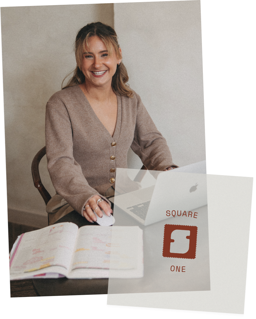 A smiling woman sitting at a desk with a laptop, open planner, and a sign with the words "SQUARE ONE" and a stamp icon.