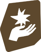 A hand holding a lit safety match with a flame in a dark background.