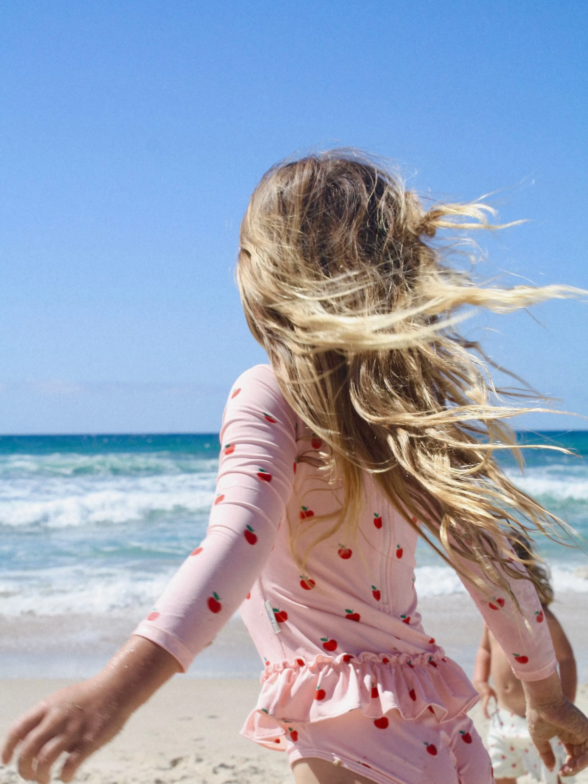 When designing these prints, we wanted to capture the feeling of warm summer days, sandy little fingers and toes, splashing in the sea spray and those playful moments that encapsulate childhood. These photos really bring the feeling behind @sukiswimc