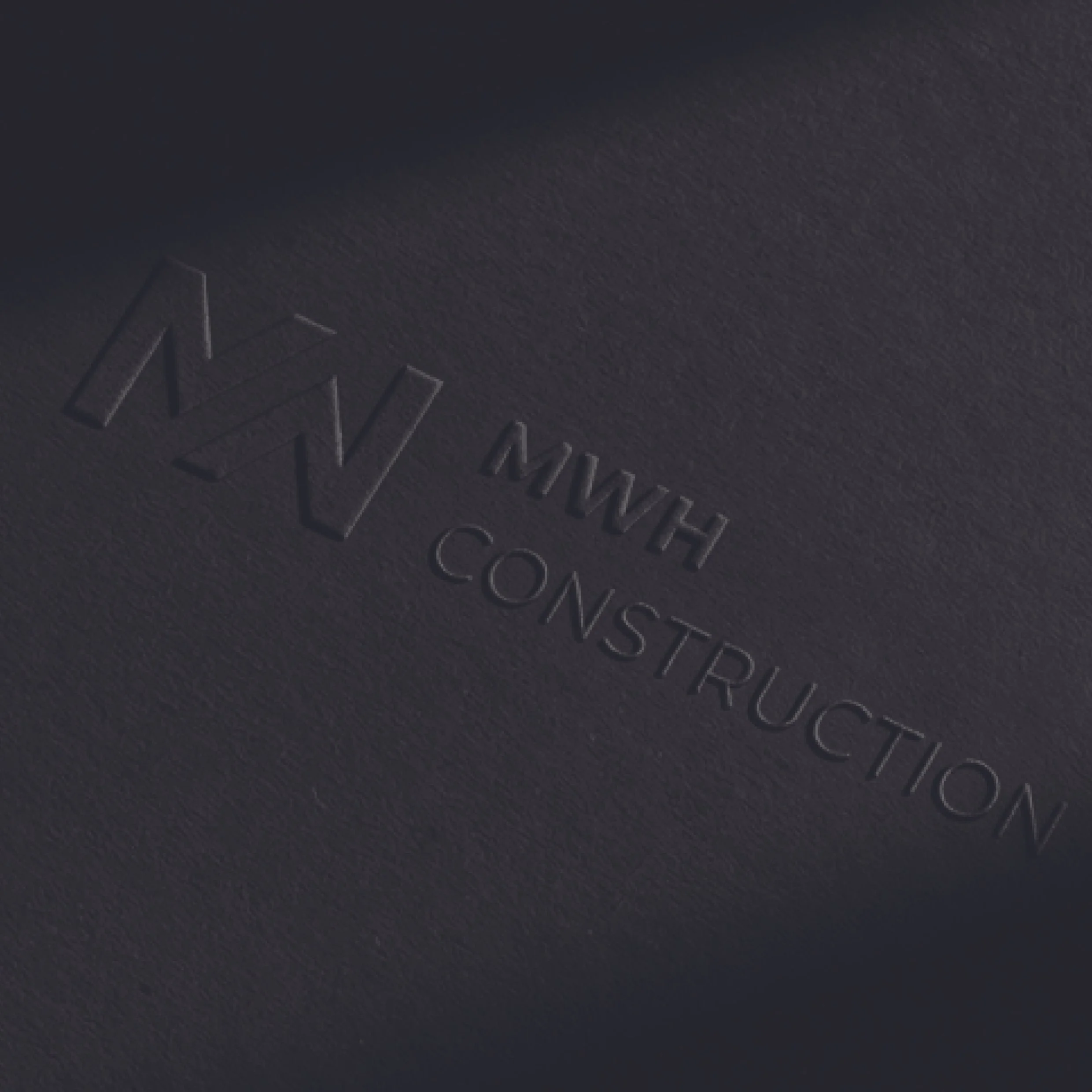 Close-up of the Intel logo embossed on a dark, textured surface.