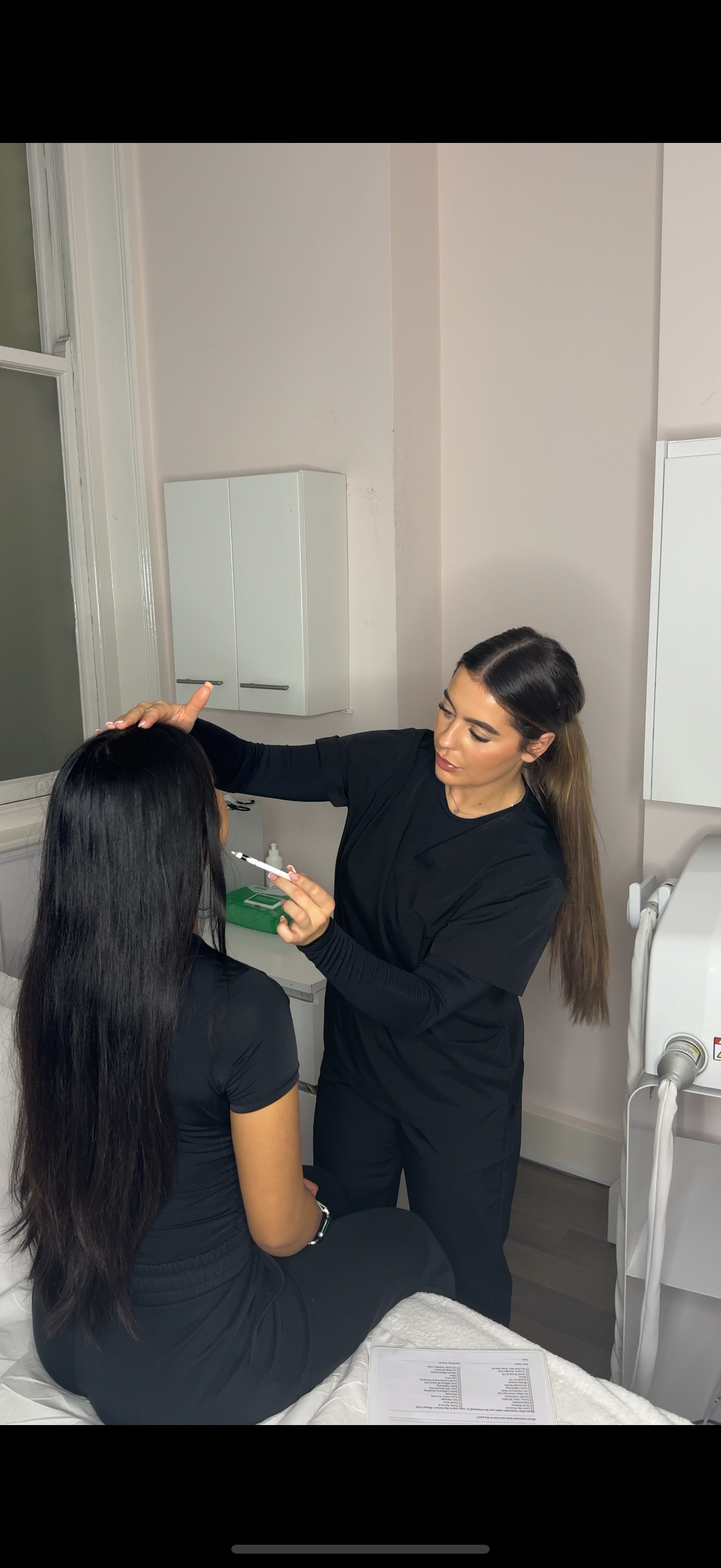 Seven Skin practitioner carrying out a client consultation