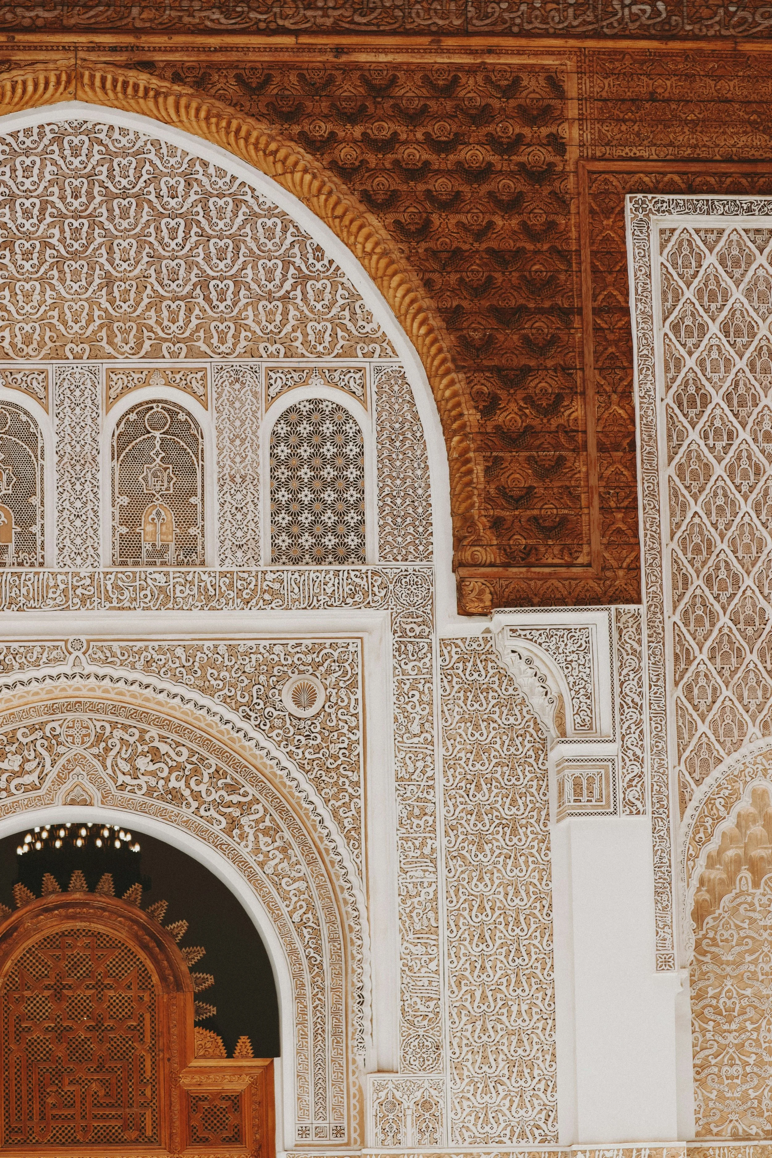 Morocco Vistas | Moorish & Andalusian Heritage — carved plasterwork and wooden entrance, Ben Youssef Madrasa, Marrakech