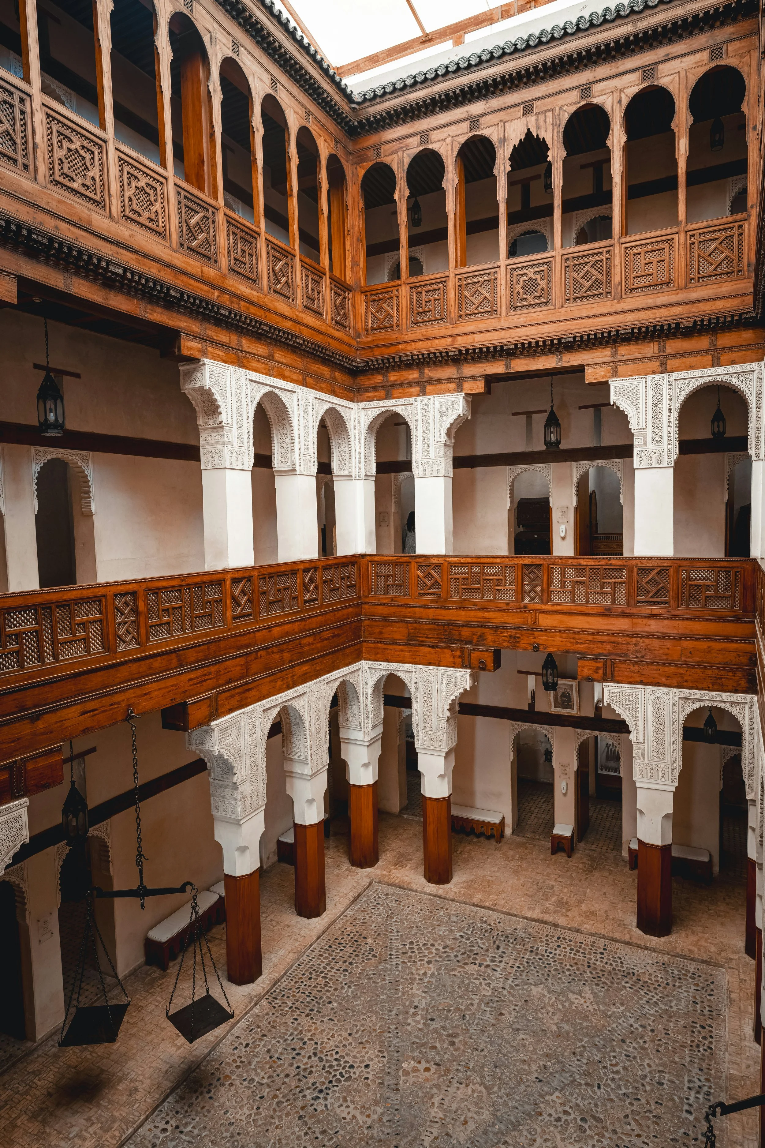 Morocco Vistas | Moorish & Andalusian Heritage — carved wooden balconies in a traditional Fez riad courtyard