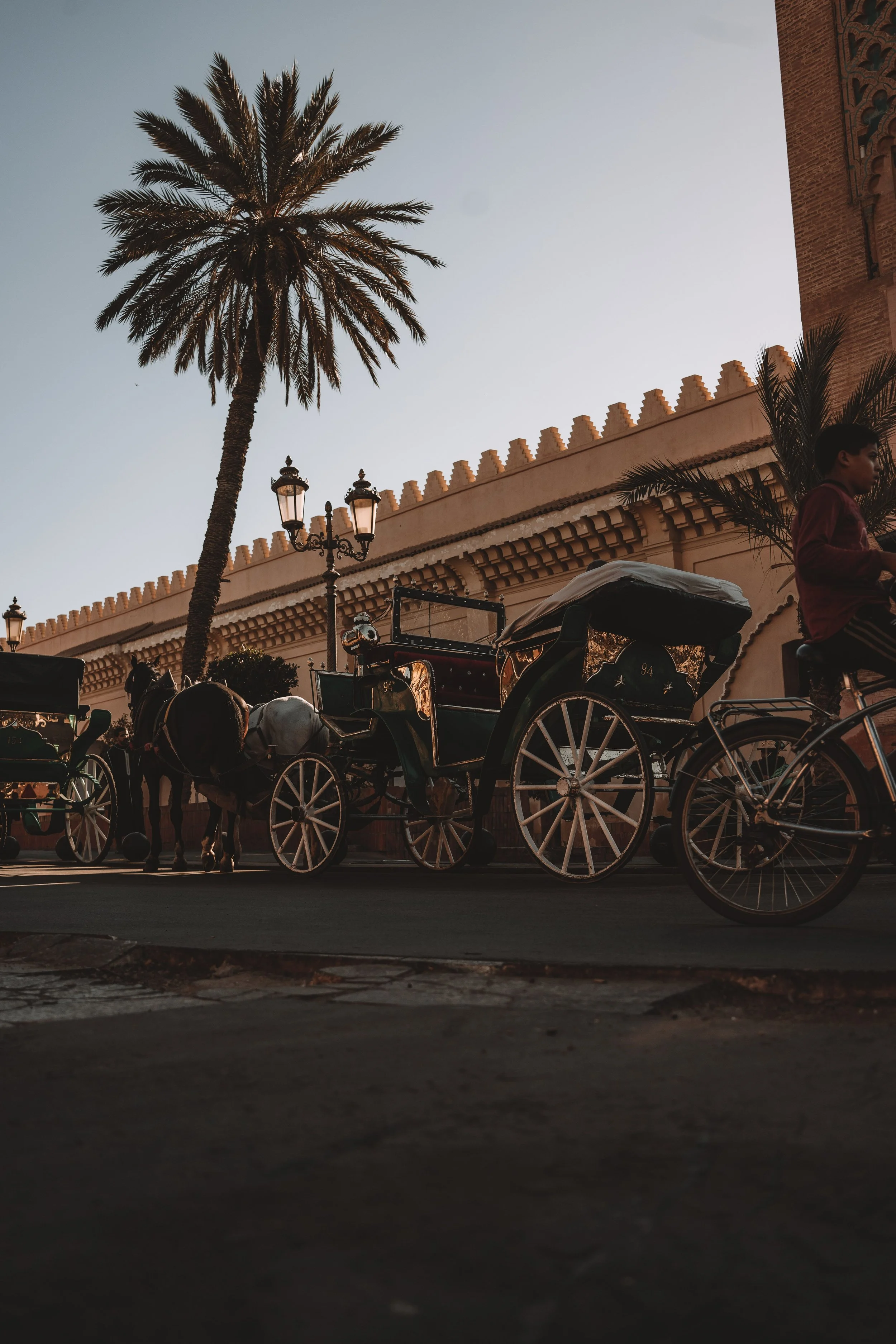Morocco Vistas | Moorish & Andalusian Heritage — sunset carriage scene near a traditional riad, Marrakech