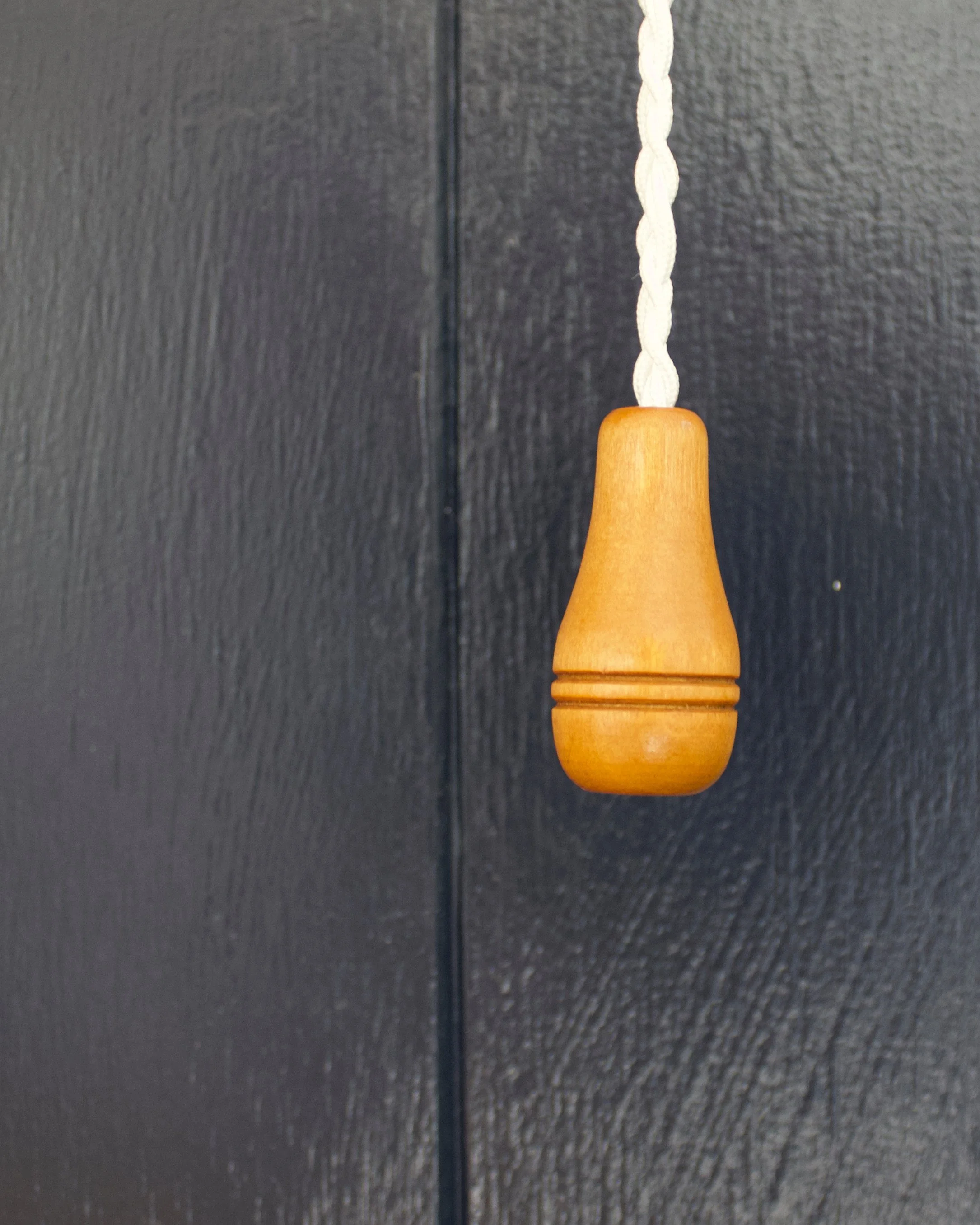 Wooden pull cord detail inside the Wildwood Estate cabin