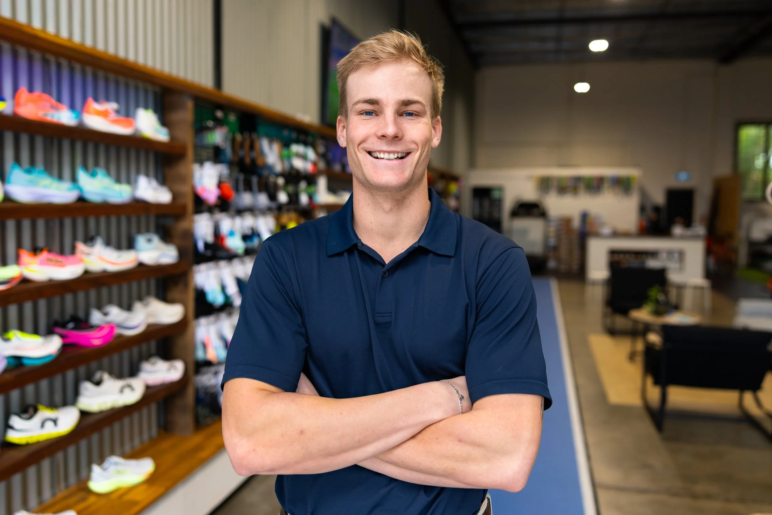 Physiotherapist at KOR Physio in East Brisbane, smiling with arms crossed in the clinic training area