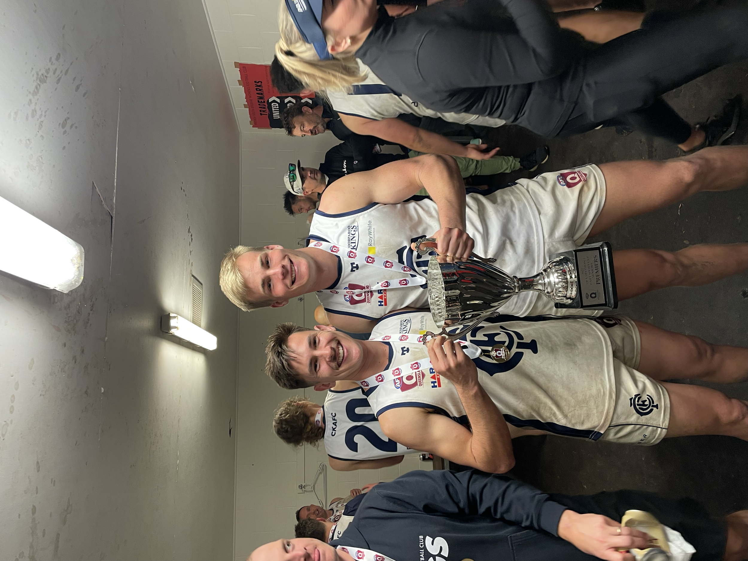 Our physiotherapist at KOR Physio with a team mate after winning a local AFL premiership.