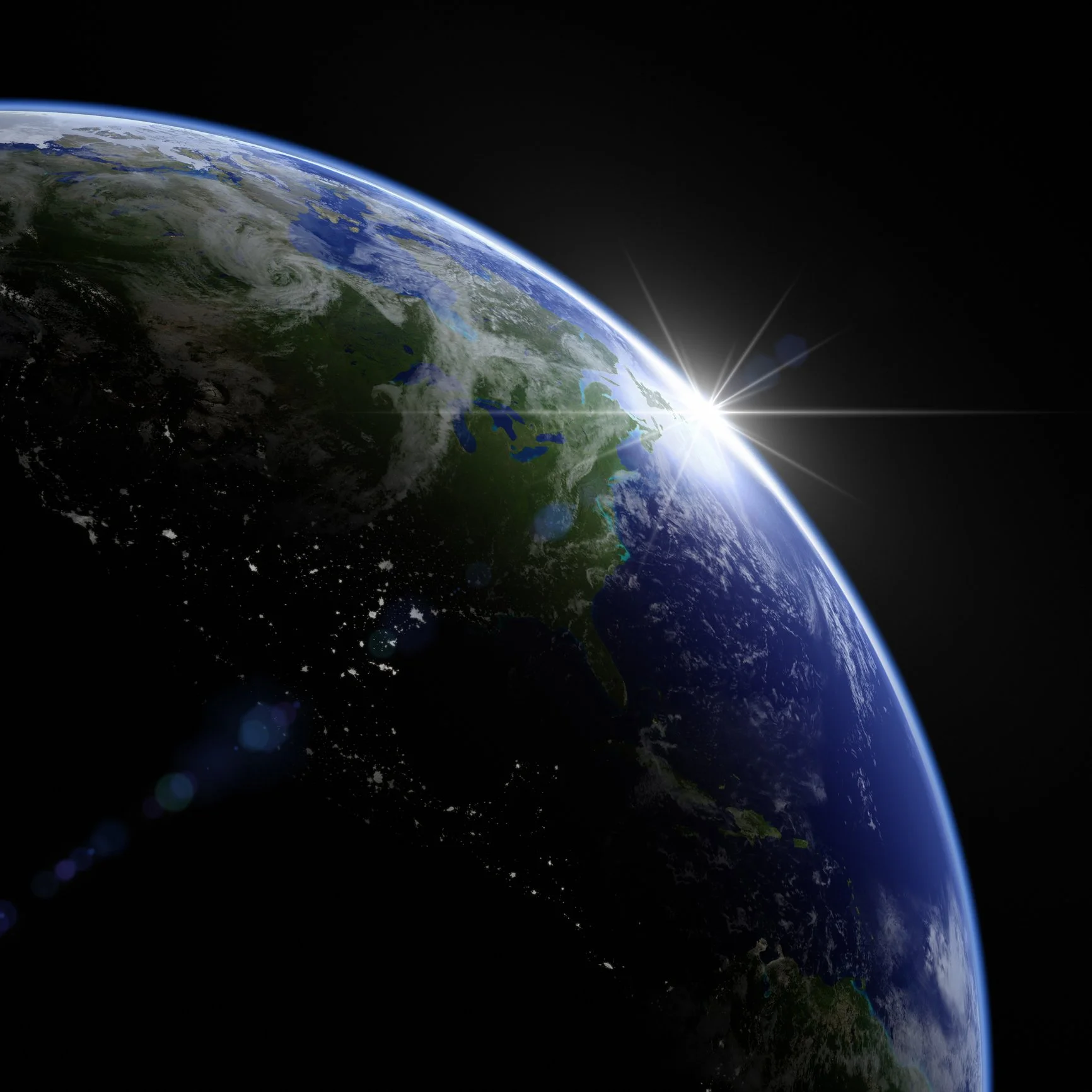 Earth from space with the sun rising at the horizon and some light reflections.