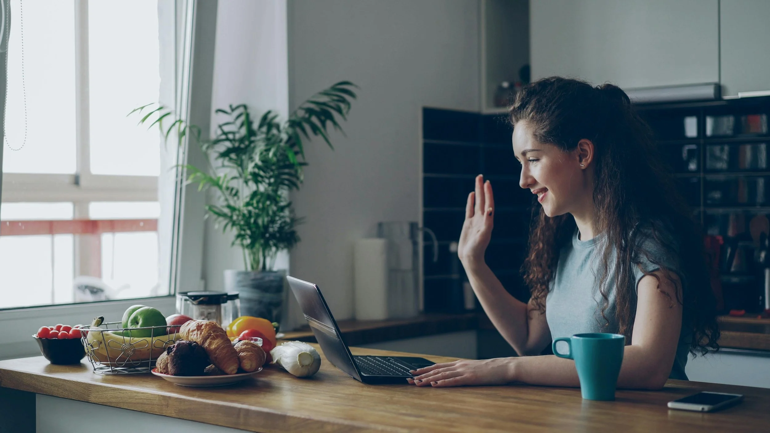 Woman participating in a clinical interview by video call from home.