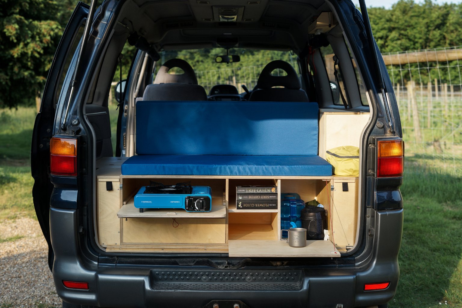  Camper unit showing single ring gas stove and drop down table 