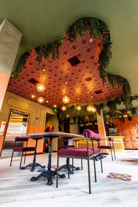 Gustavo's Mexican Grill - Louisville KY -Modern restaurant interior highlighting a custom wood ceiling feature that frames and accentuates hanging globe light fixtures, emphasizing craftsmanship and architectural detailing above the dining area.
