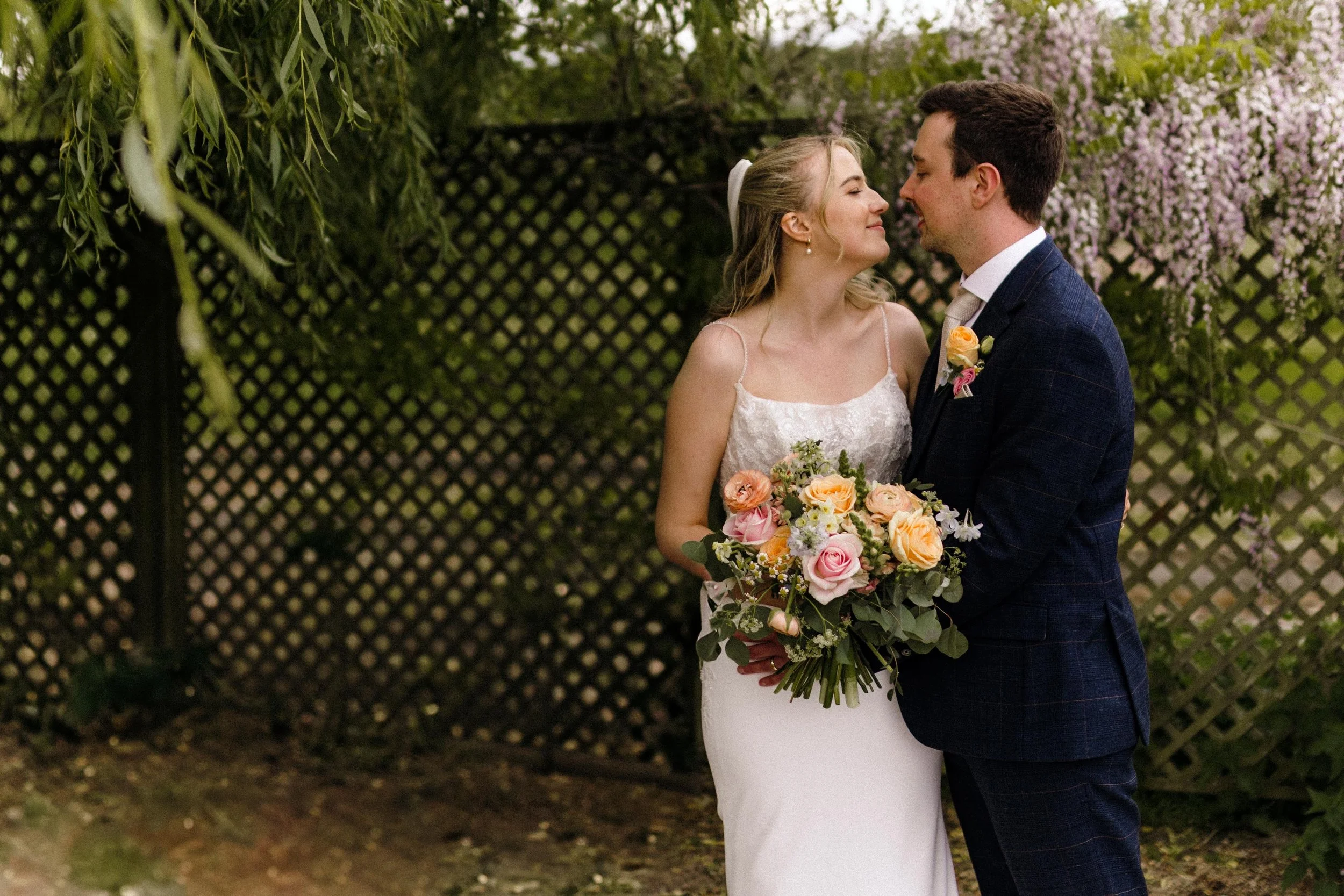 Bride and groom gazing into each other's eyes during couple portrait session at Kedleston Country House