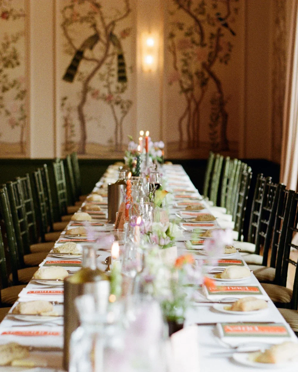Long wedding breakfast table with flowers, candles and elegant place settings at The George in Rye.
