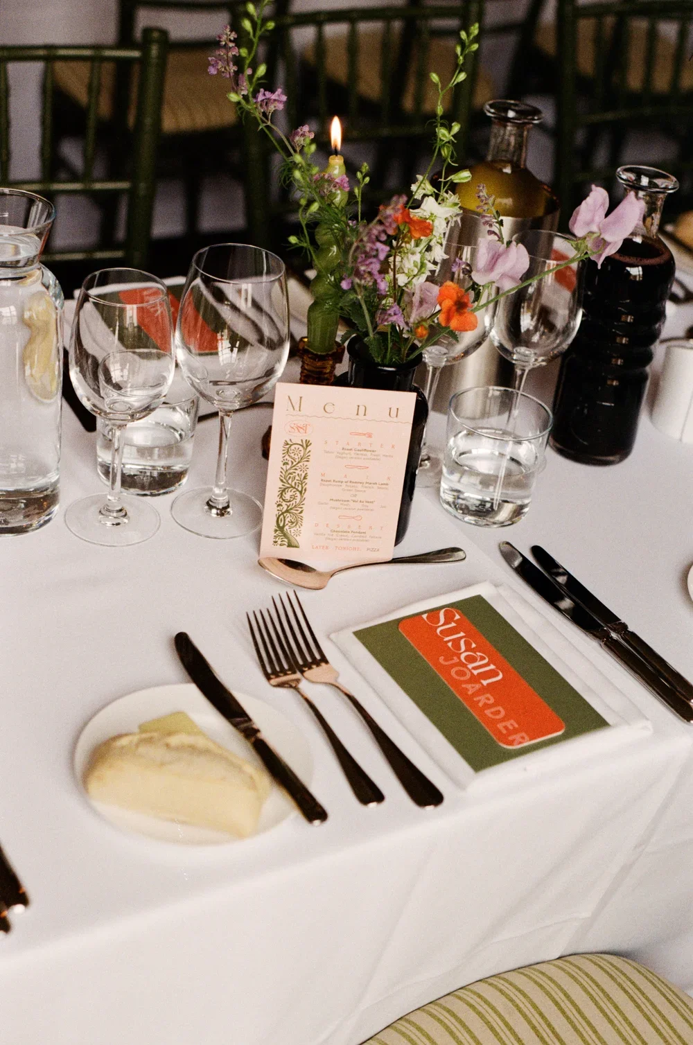 Elegant wedding table setting with glassware, flowers and candlelight at The George in Rye.