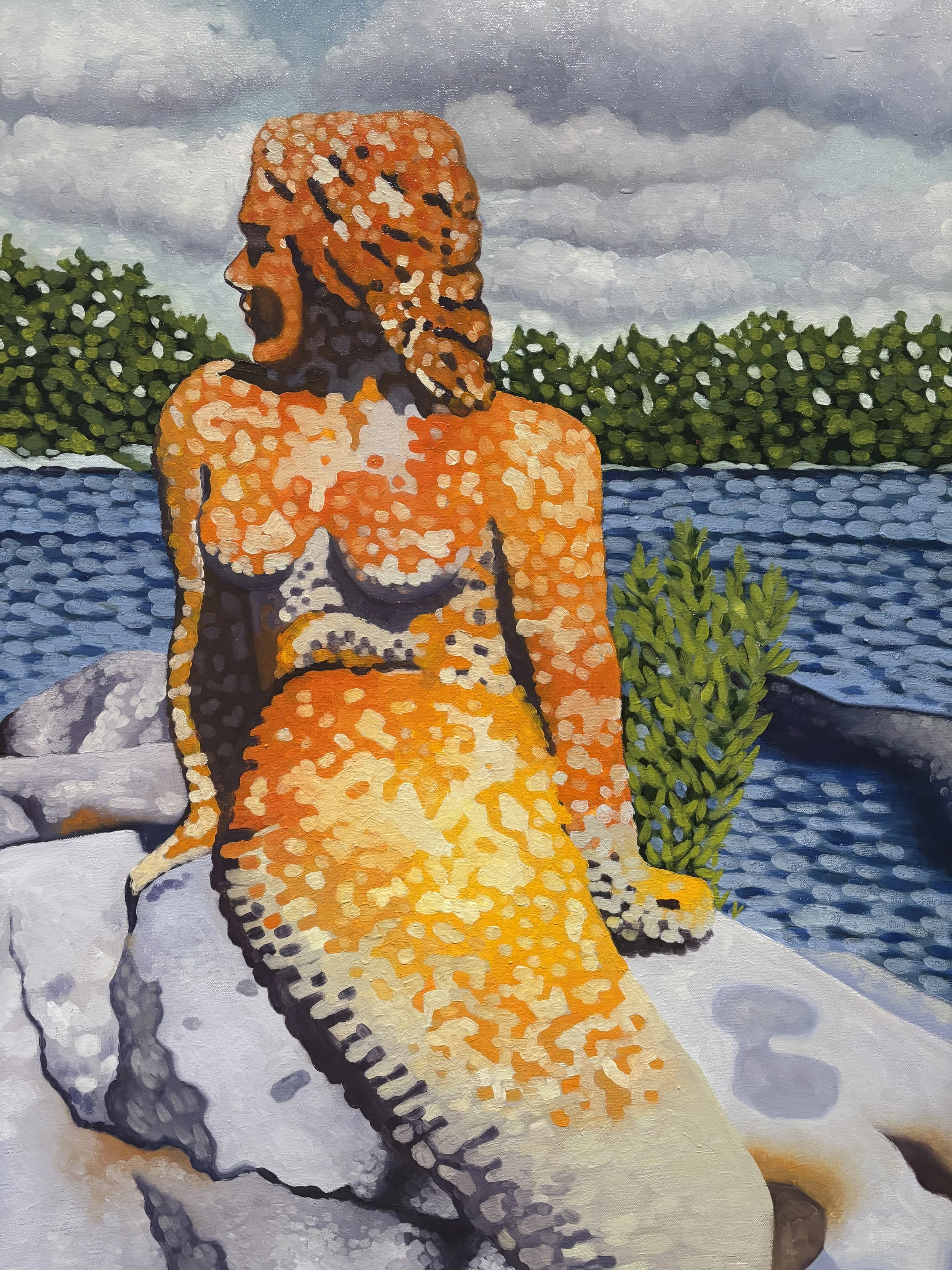A painting of the 'Rainy Lake Mermaid,' sitting outdoors on a large rock near a body of water, with greenery and clouds in the background.