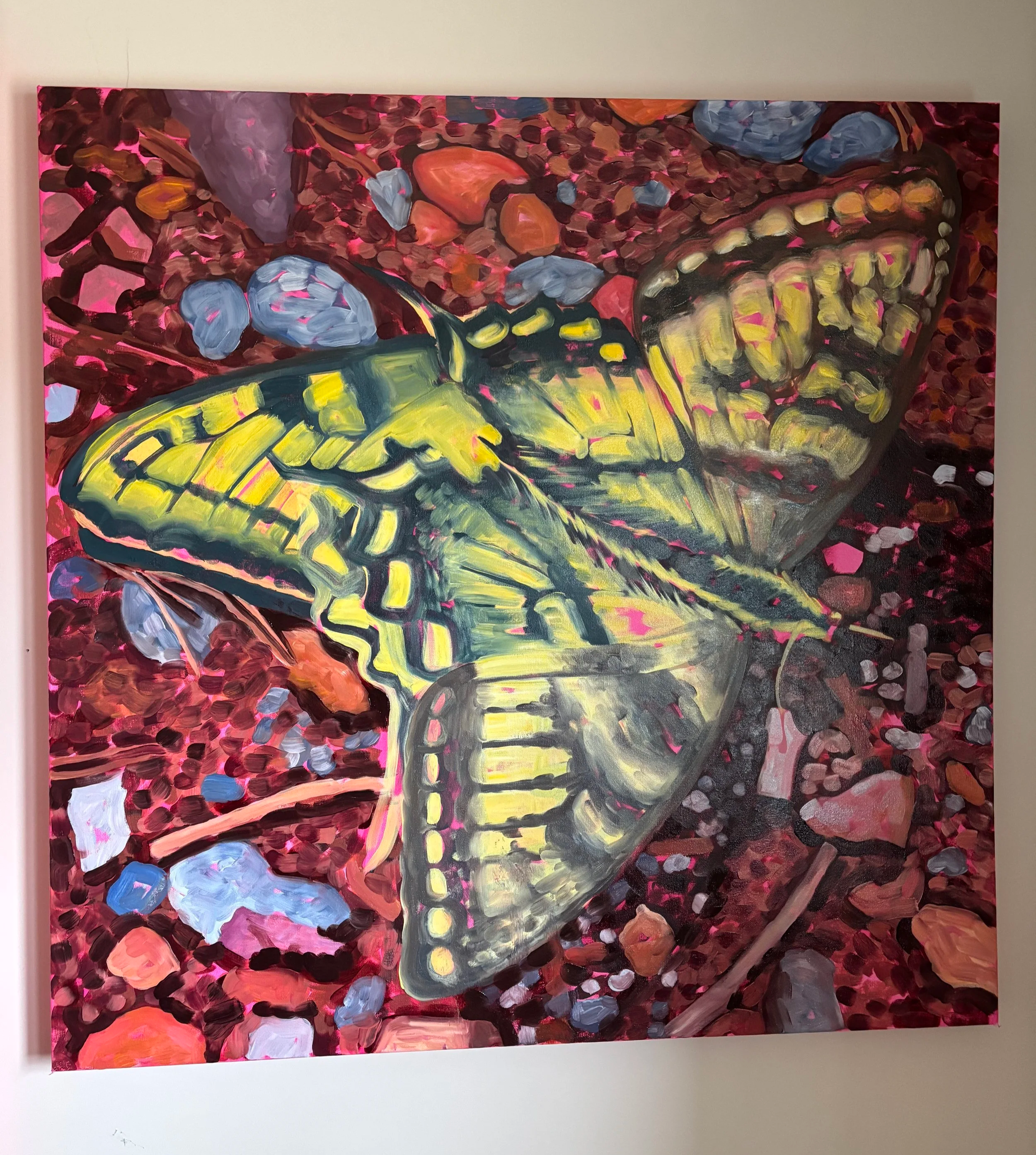 An abstract painting of a yellow butterfly with black outlines amidst a background of various colored dots and shapes, including blue, orange, pink, and purple, created with bold brushstrokes on a rectangular canvas.