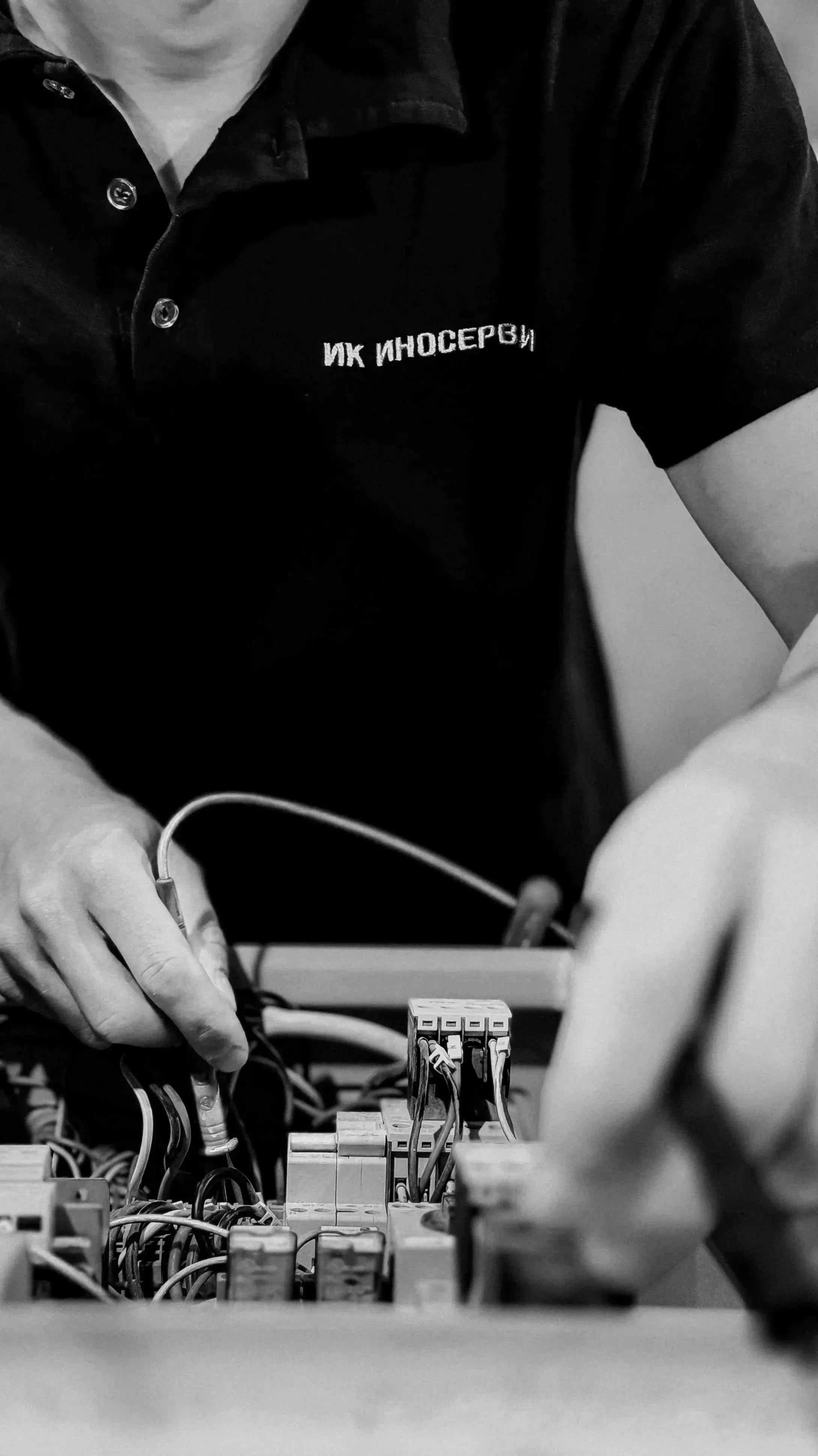 A person working with electrical wires and components, possibly assembling or repairing electronic equipment.