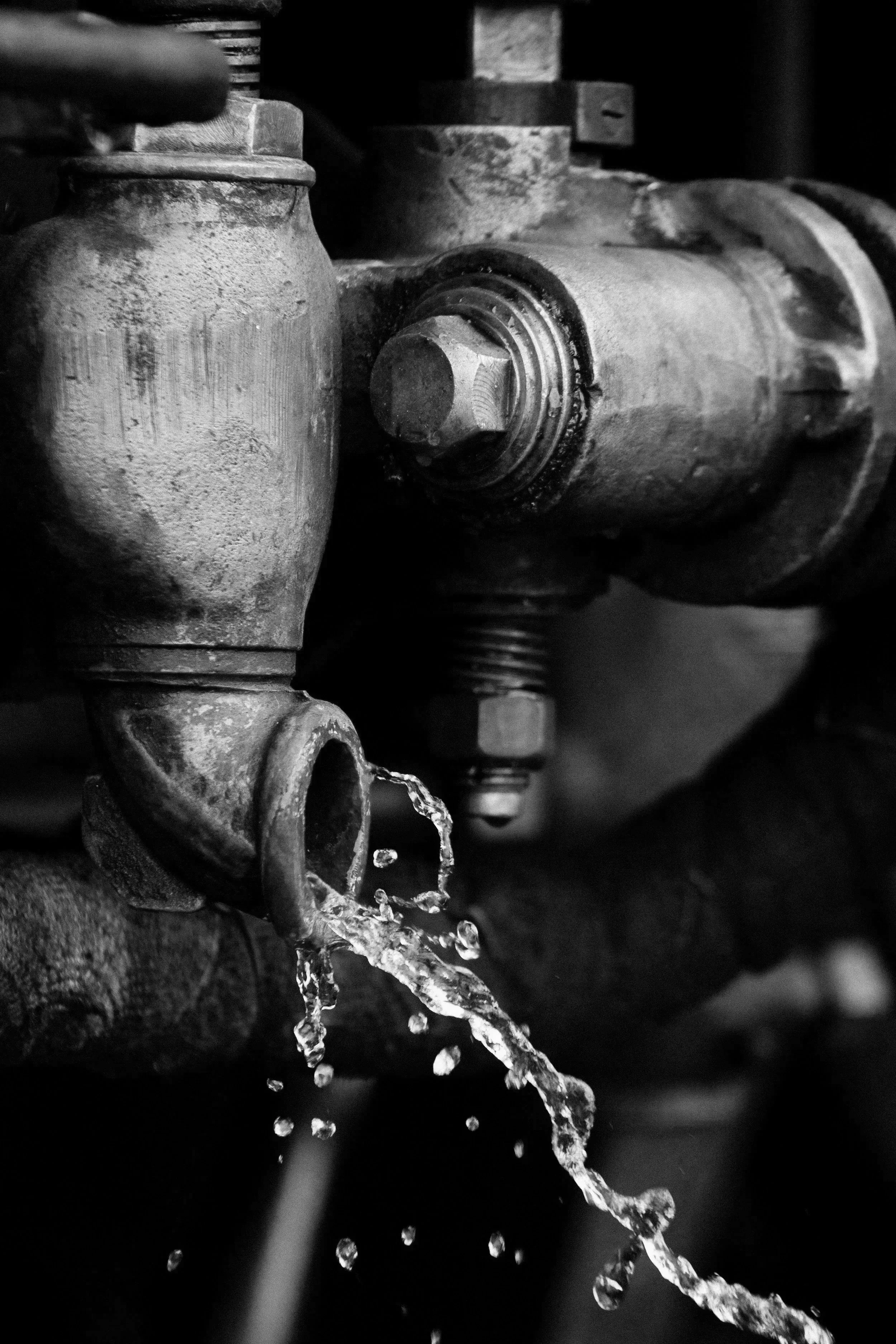 Close-up of water valve with water flowing out.