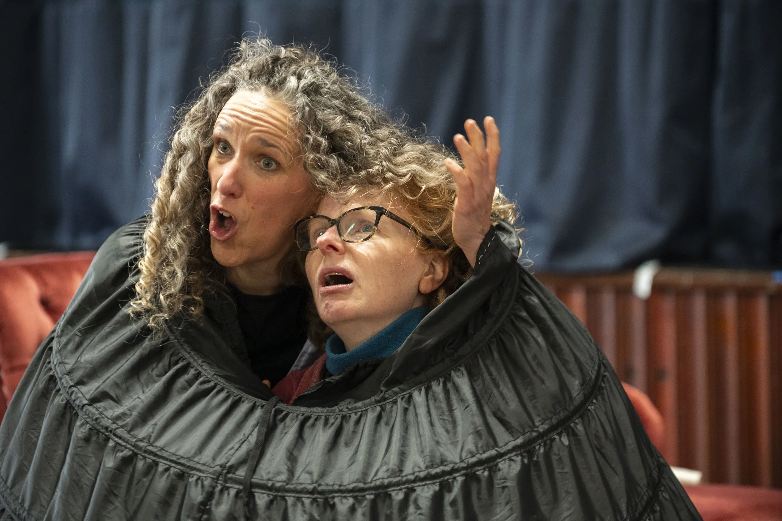 Her Bloody Majesty R&D, 2026. Two women are squished into a crinoline skirt, their heads poking through the top.