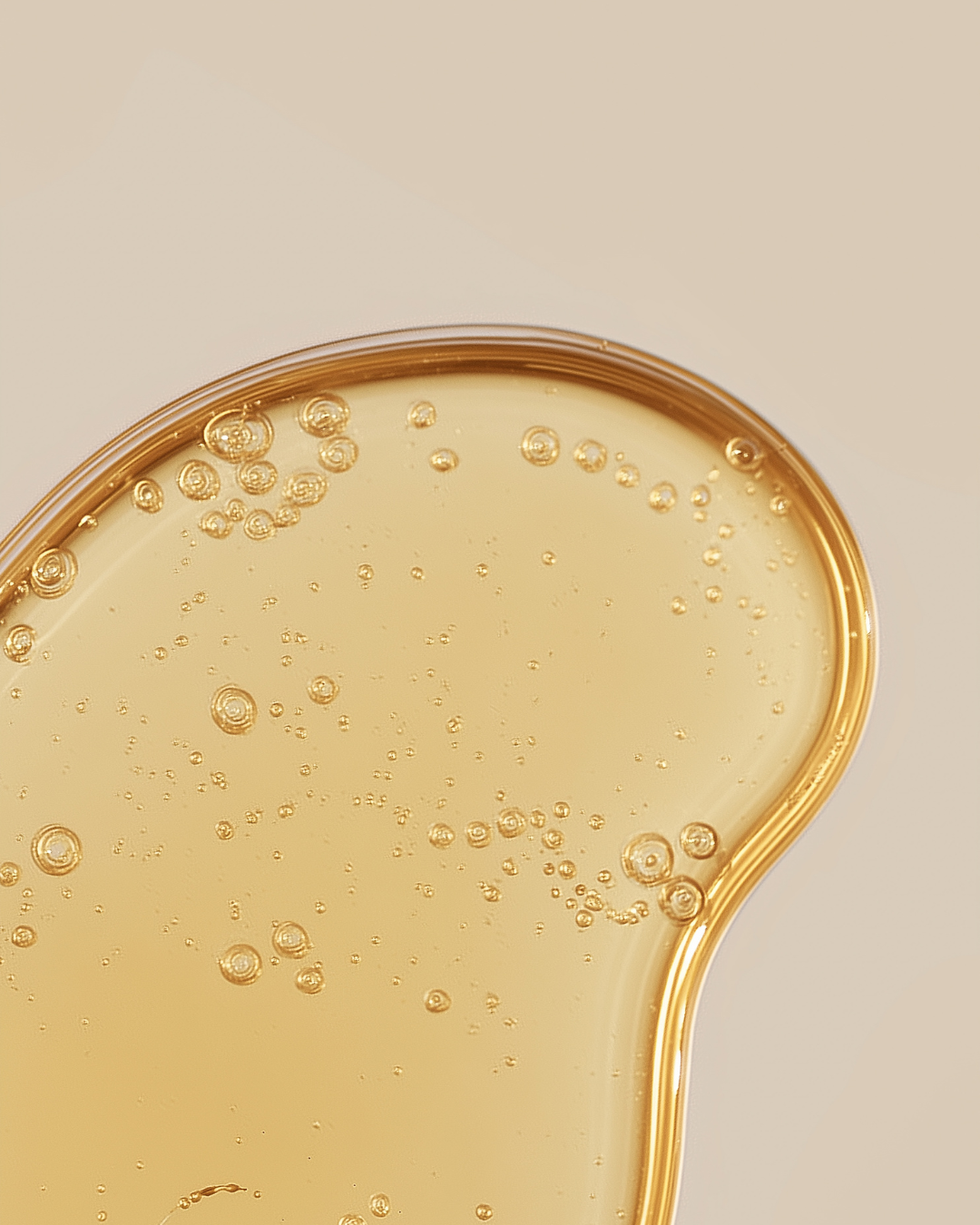 Close-up of a golden skin serum with bubbles