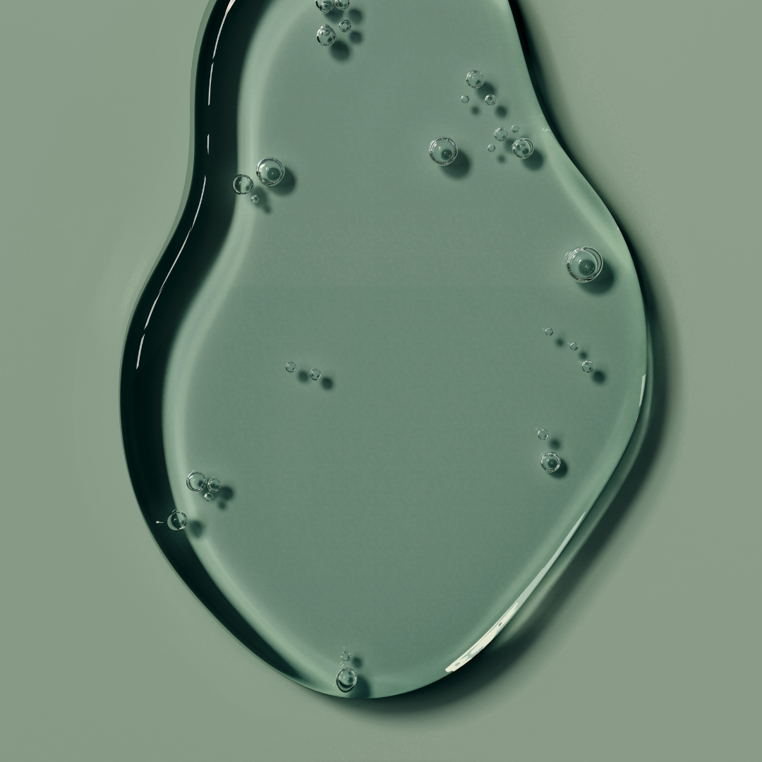 Close-up of a puddle of translucent green skin serum