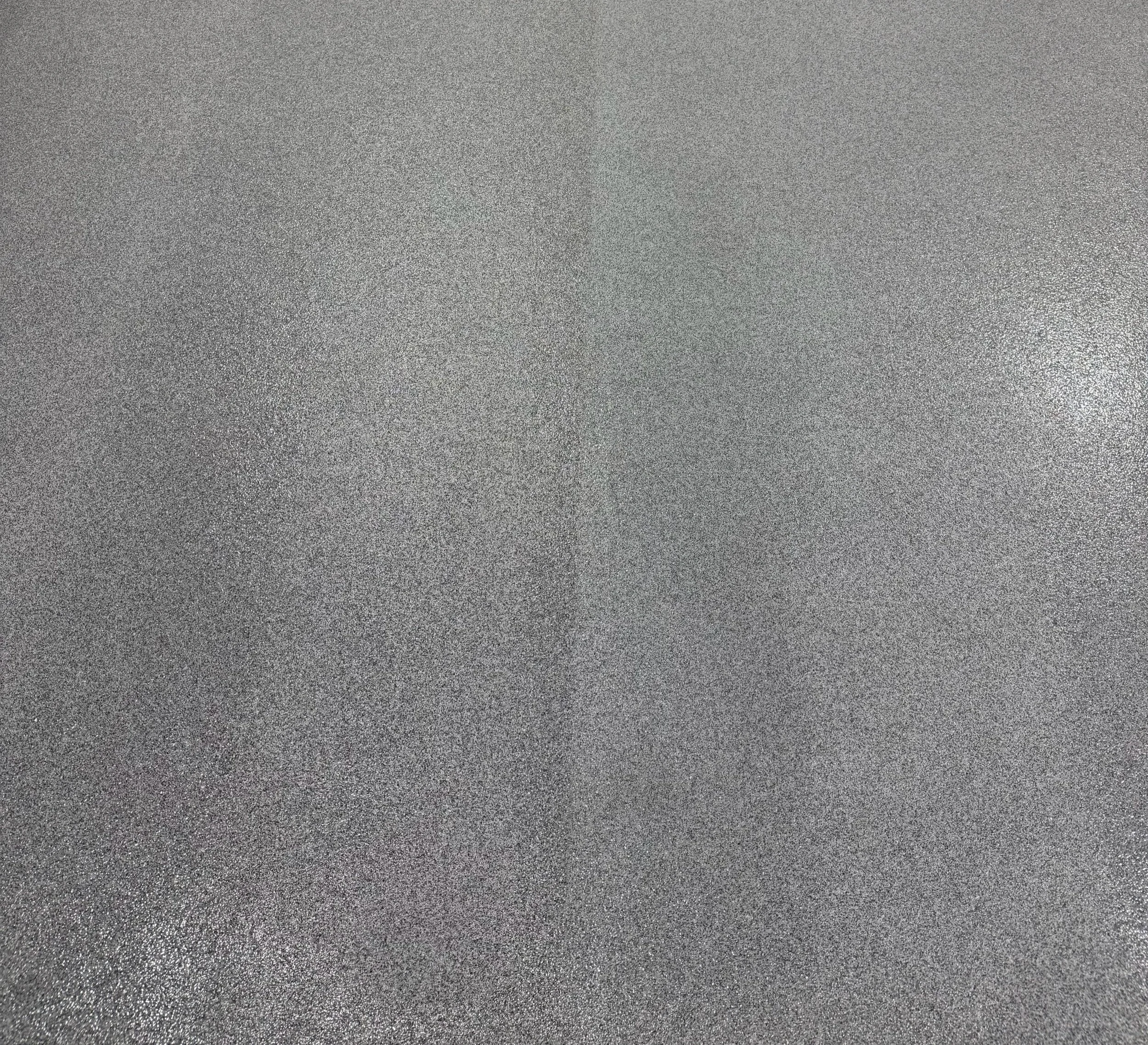 Close up of a Quartz System. A flat, textured surface in shades of gray with a subtle gloss.