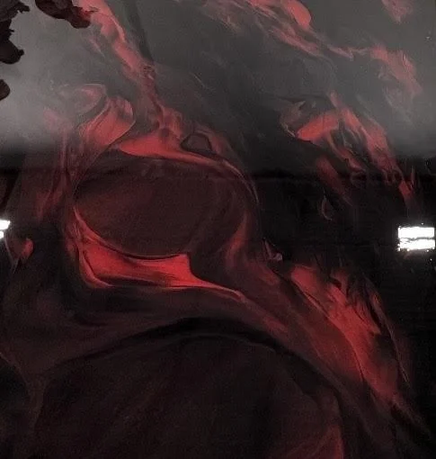 Abstracts of red and black swirling patterns.