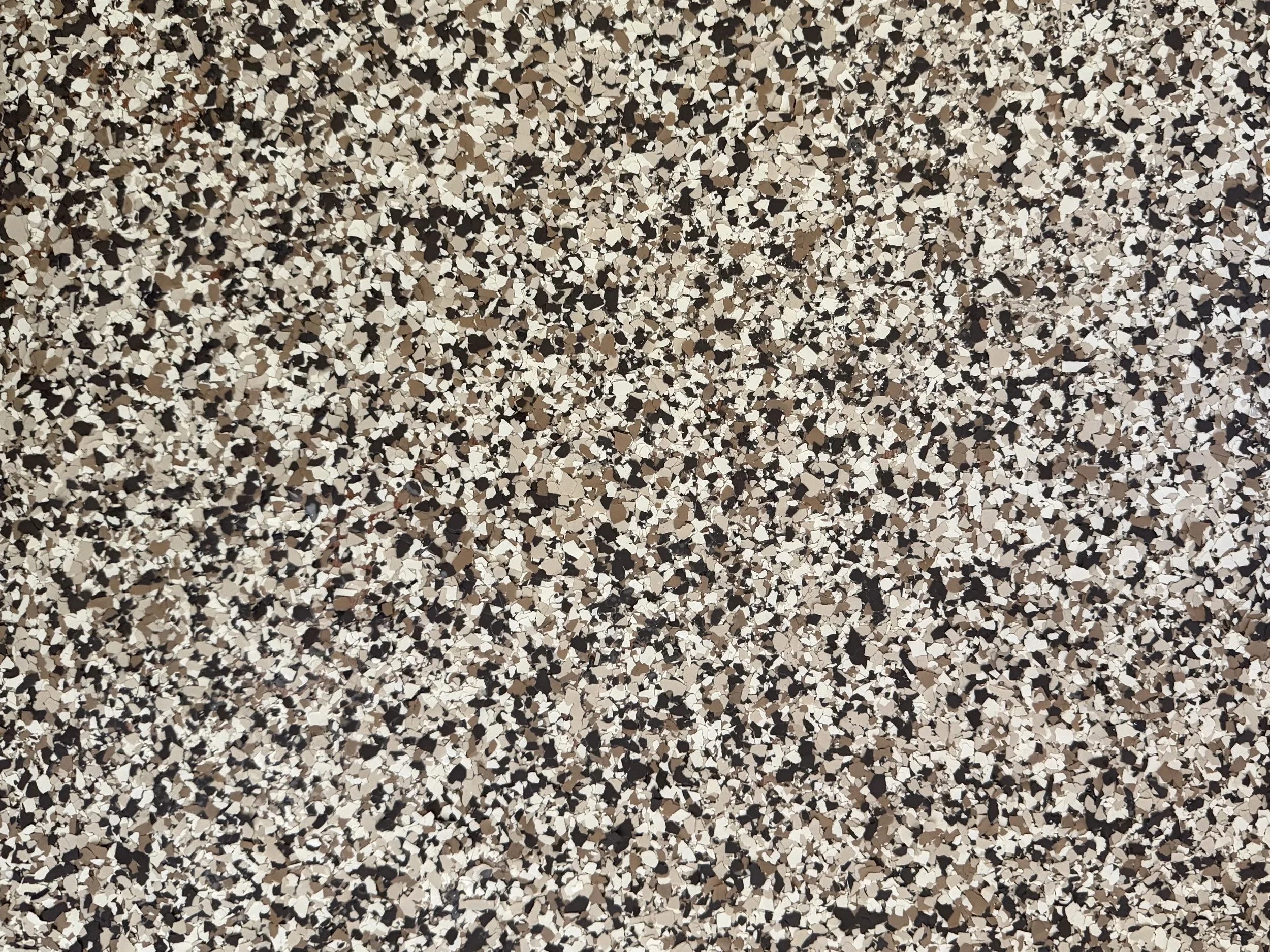 Close-up of a Flake system with black, white, beige, and brown.