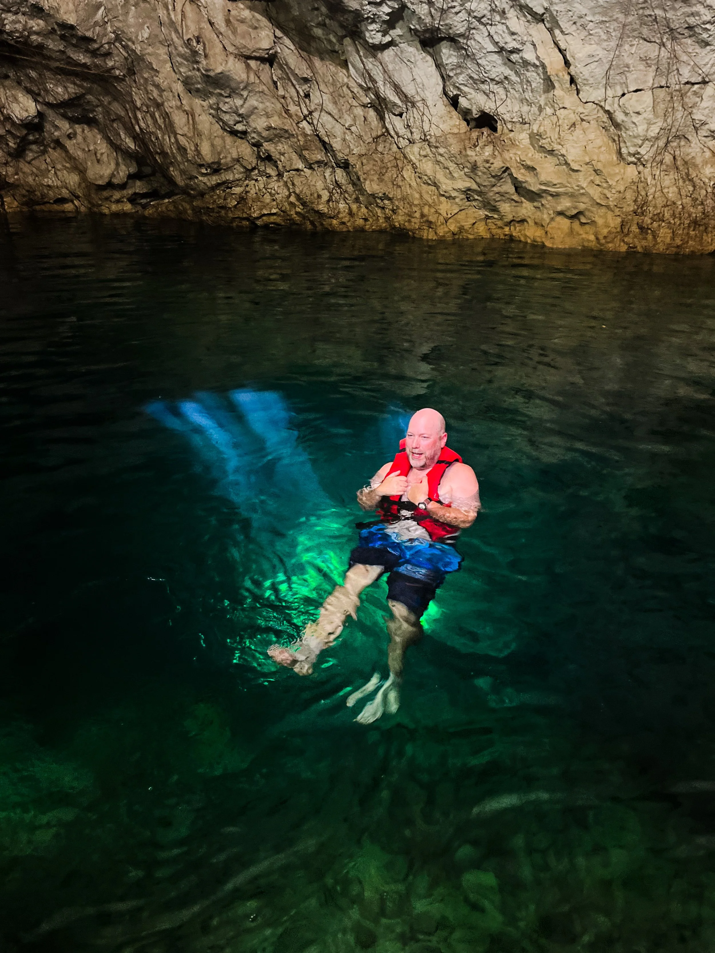 Traveler swimming in a cenote during a private shore excursion from Progreso, Yucatán