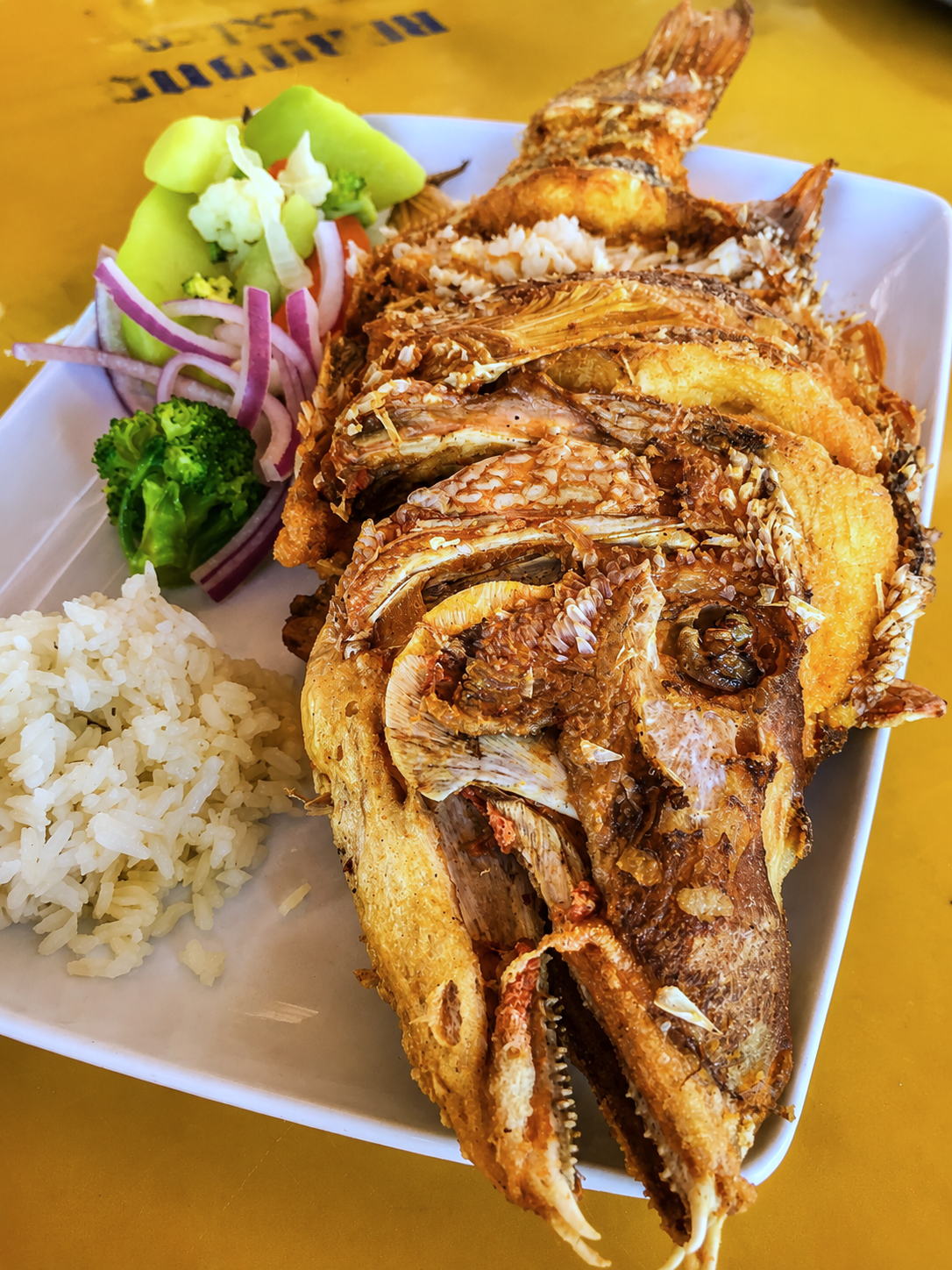 Traditional seafood meal featuring whole fried fish, served along the Yucatán coast and offering an authentic taste of the region’s fishing heritage and cuisine.