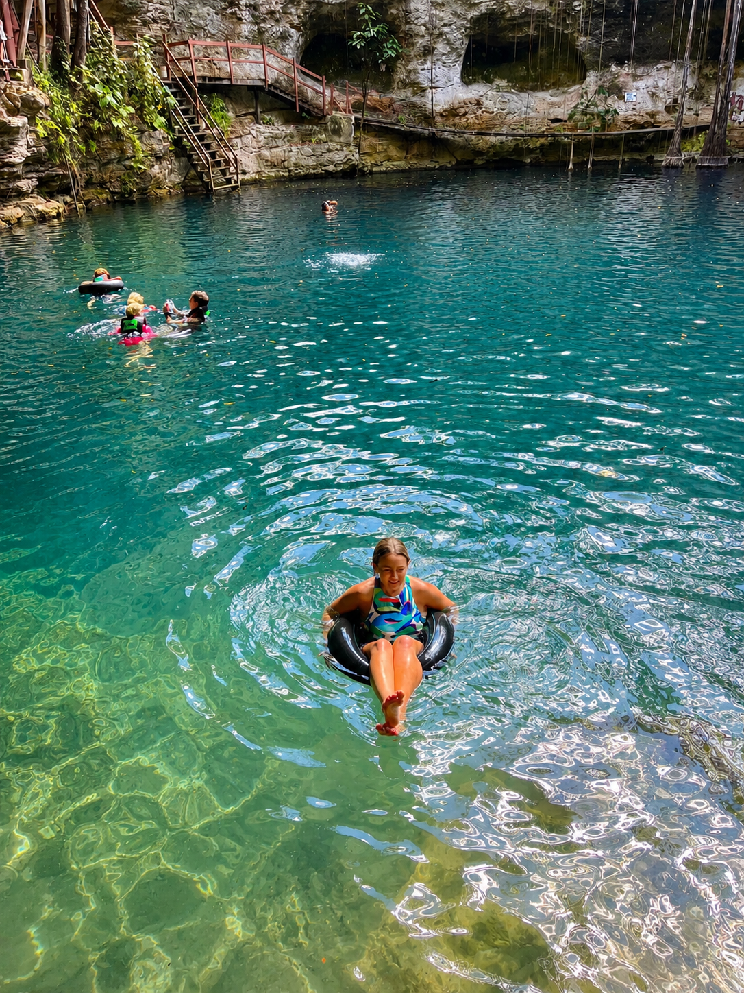 Traveler swimming in a natural cenote in Yucatán, Mexico