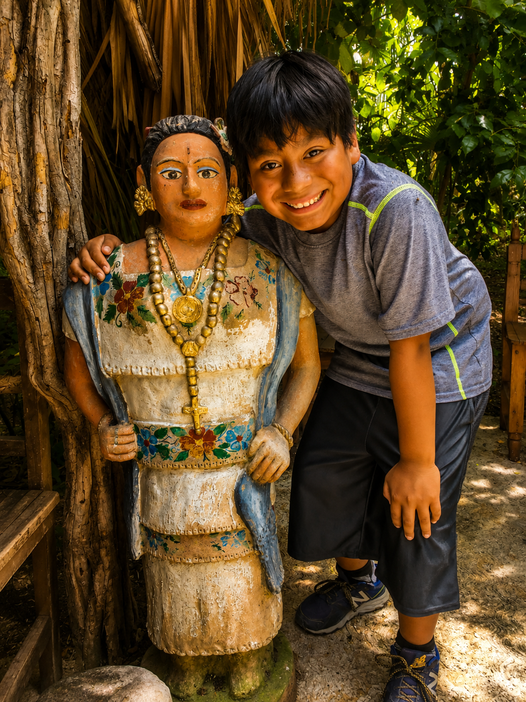 Young traveler with a traditional figure in rural Yucatán