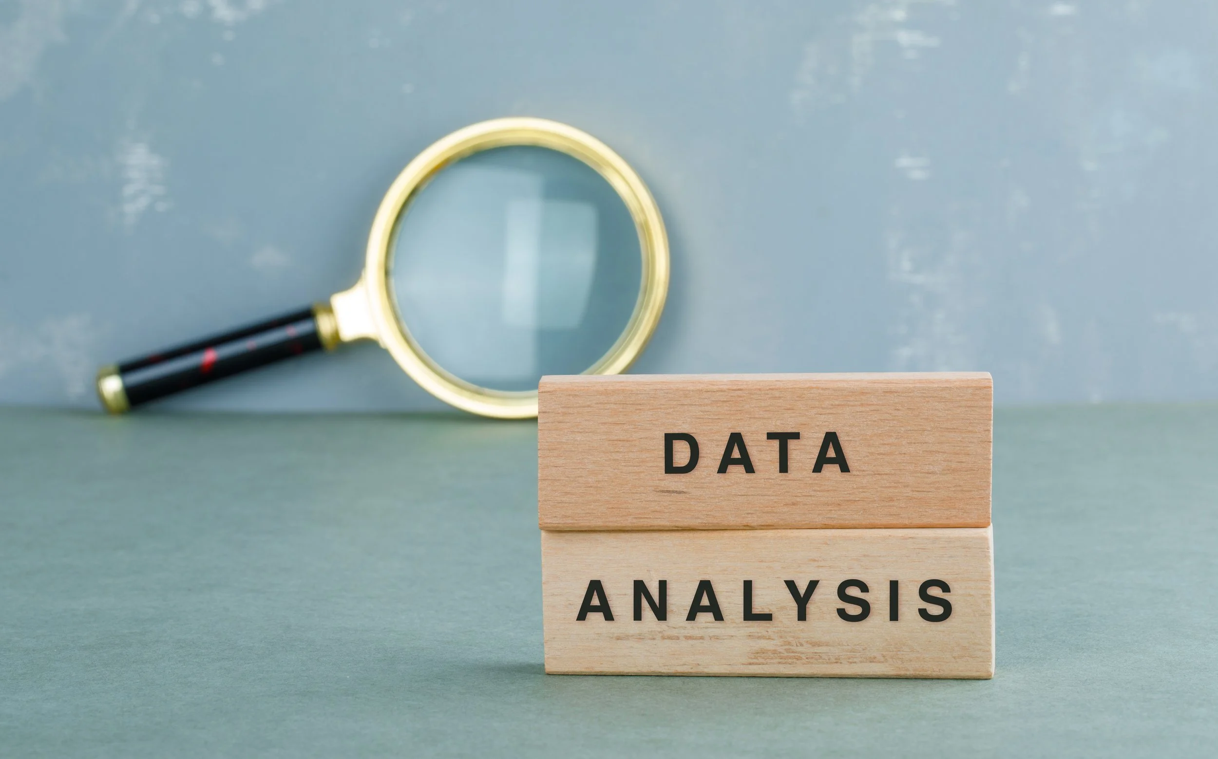 conceptual-data-analysis-with-wooden-blocks-magnifying-glass-side-view.jpg