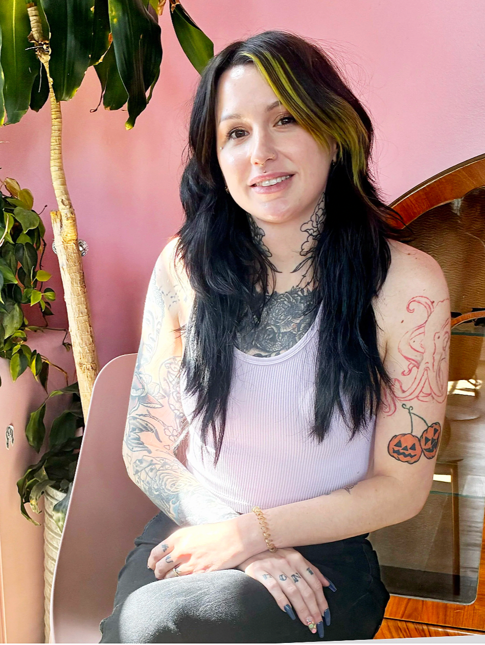 Jeri Oakley Hamilton, hair color specialist, with long black layers and a chartreuse money piece