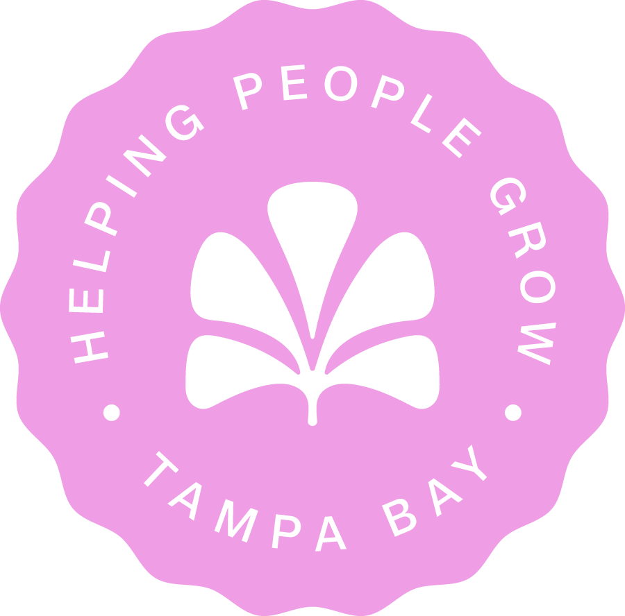 Pink scalloped circular badge with black text and a black floral design. Text reads 'Helping People Grow' around the top and 'Tampa Bay' at the bottom.