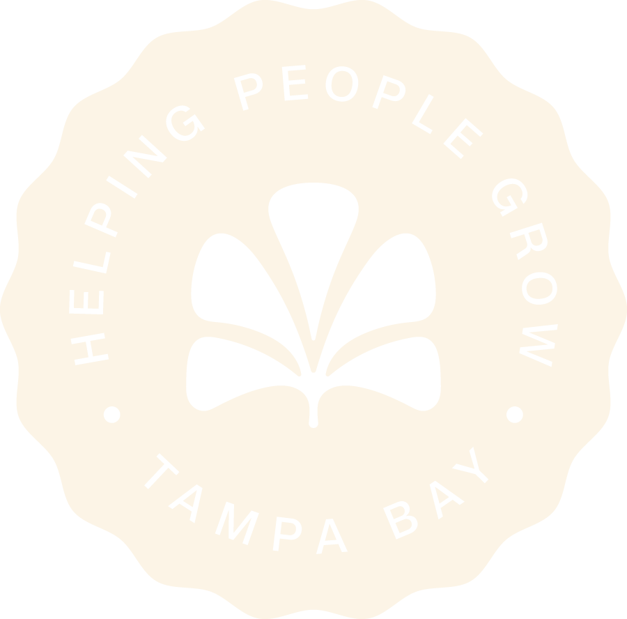 A circular logo with jagged edges featuring a stylized black flower in the center. Text around the flower reads 'Helping People Grow' at the top and 'Tampa Bay' at the bottom.