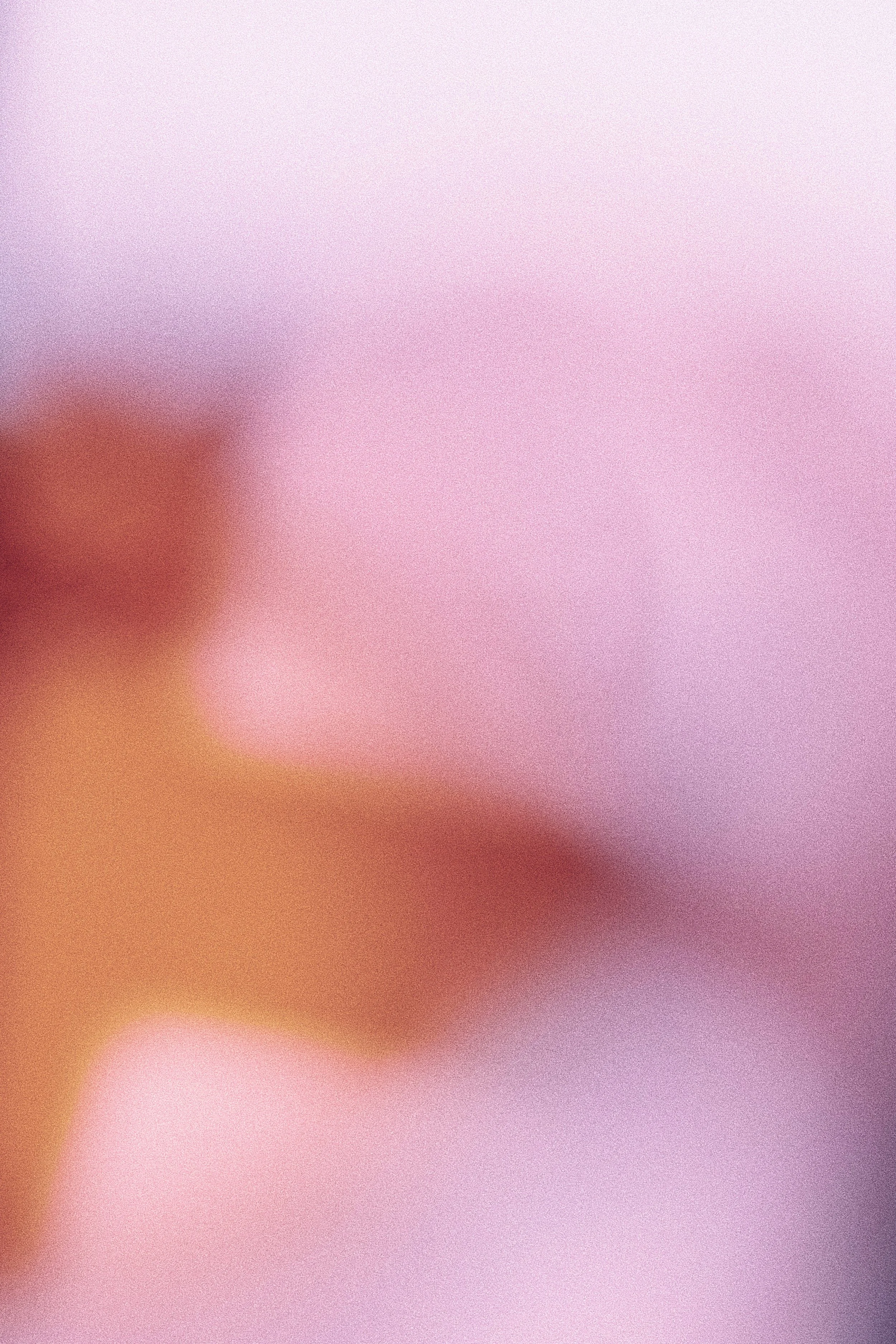 A colorful, abstract, blurred background with soft pink, purple, and orange hues.