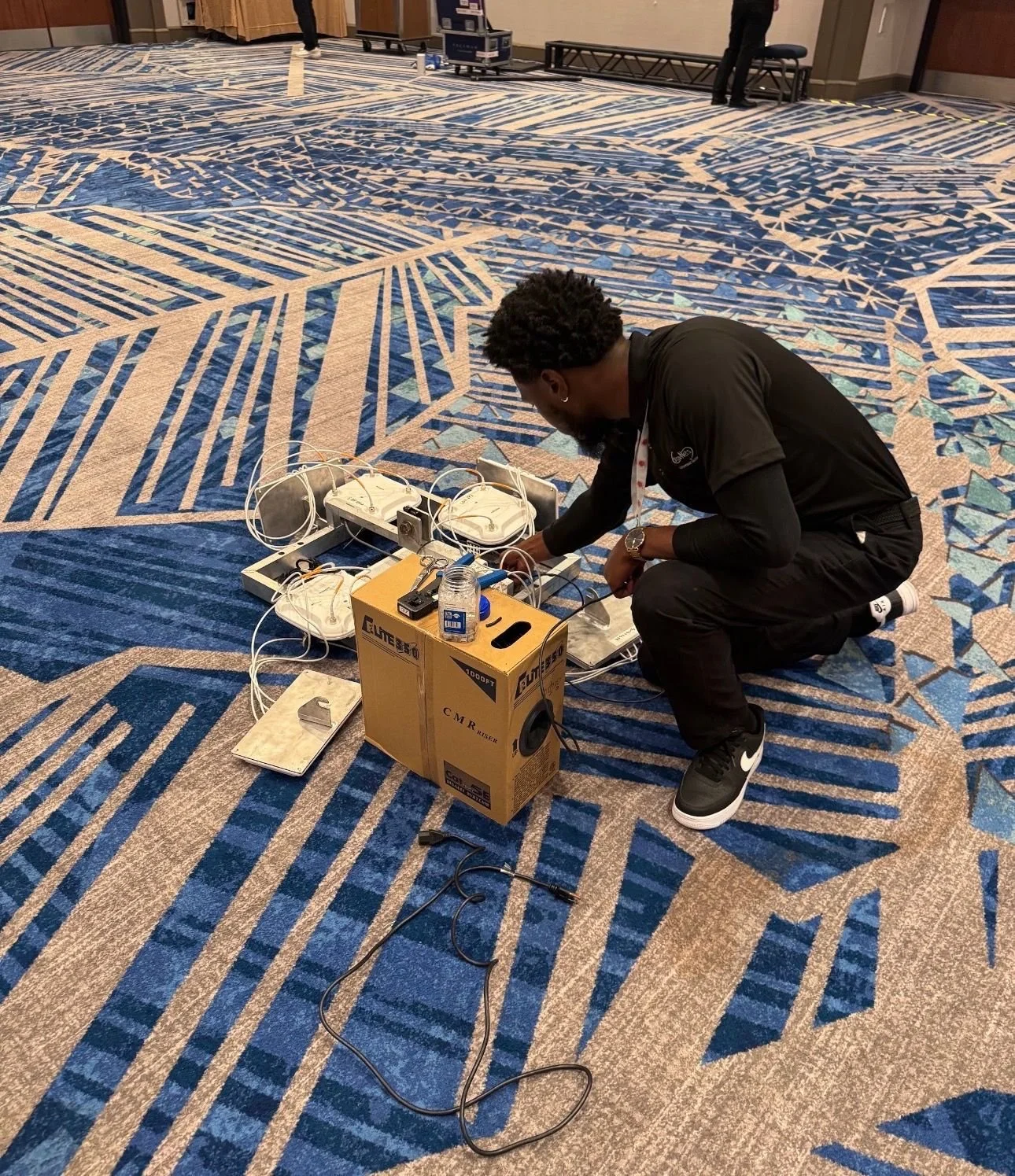 A showNets Technician running network cables on the Trade Show Expo Floor