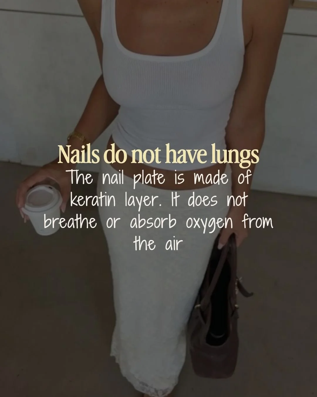A woman wearing a white tank top and a white skirt, holding a coffee cup in one hand and a bag in the other, with an overlaid text explaining that nails do not have lungs because they are made of keratin and do not breathe or absorb oxygen.