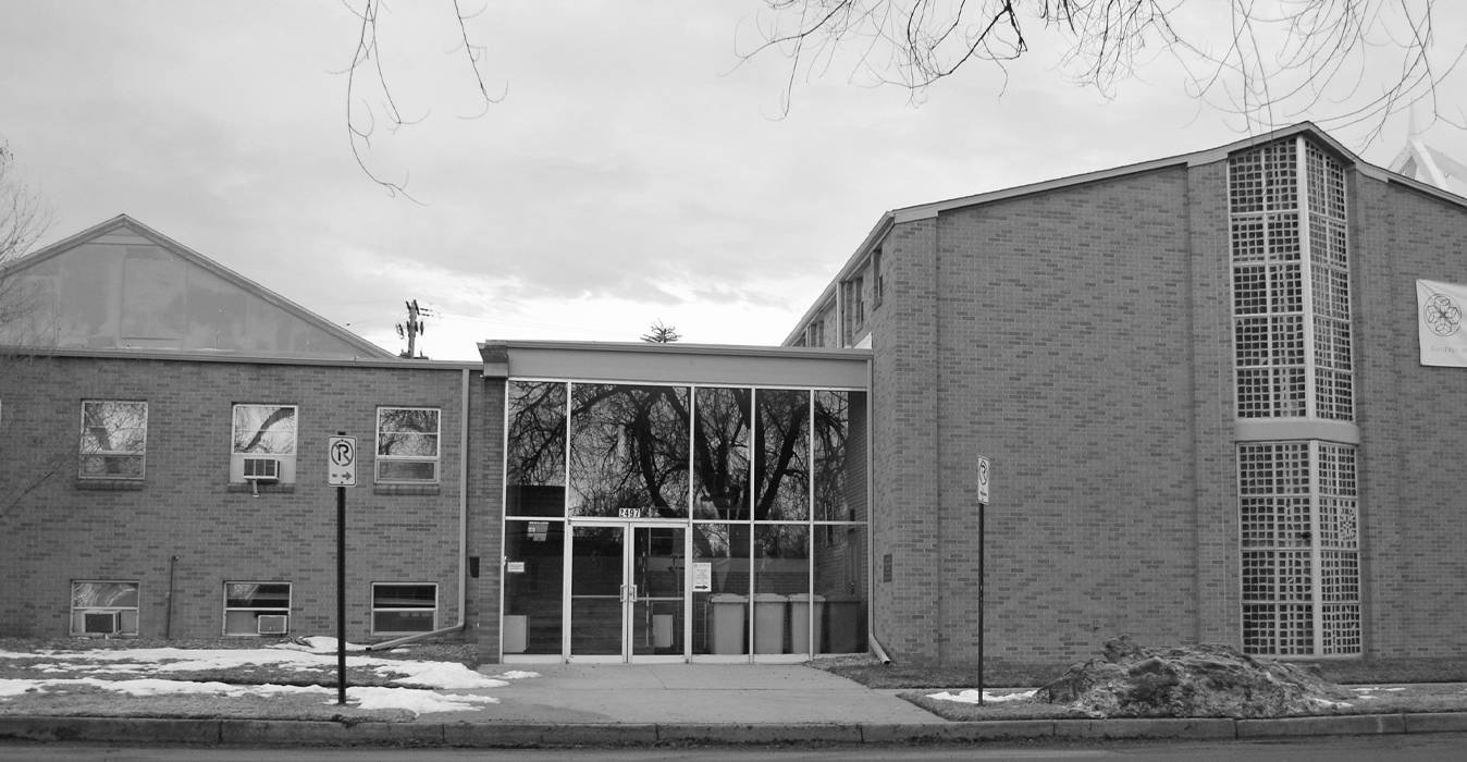 The main entrance to the Universal Kempo Karate school, a glass atrium with brick structures on either side.