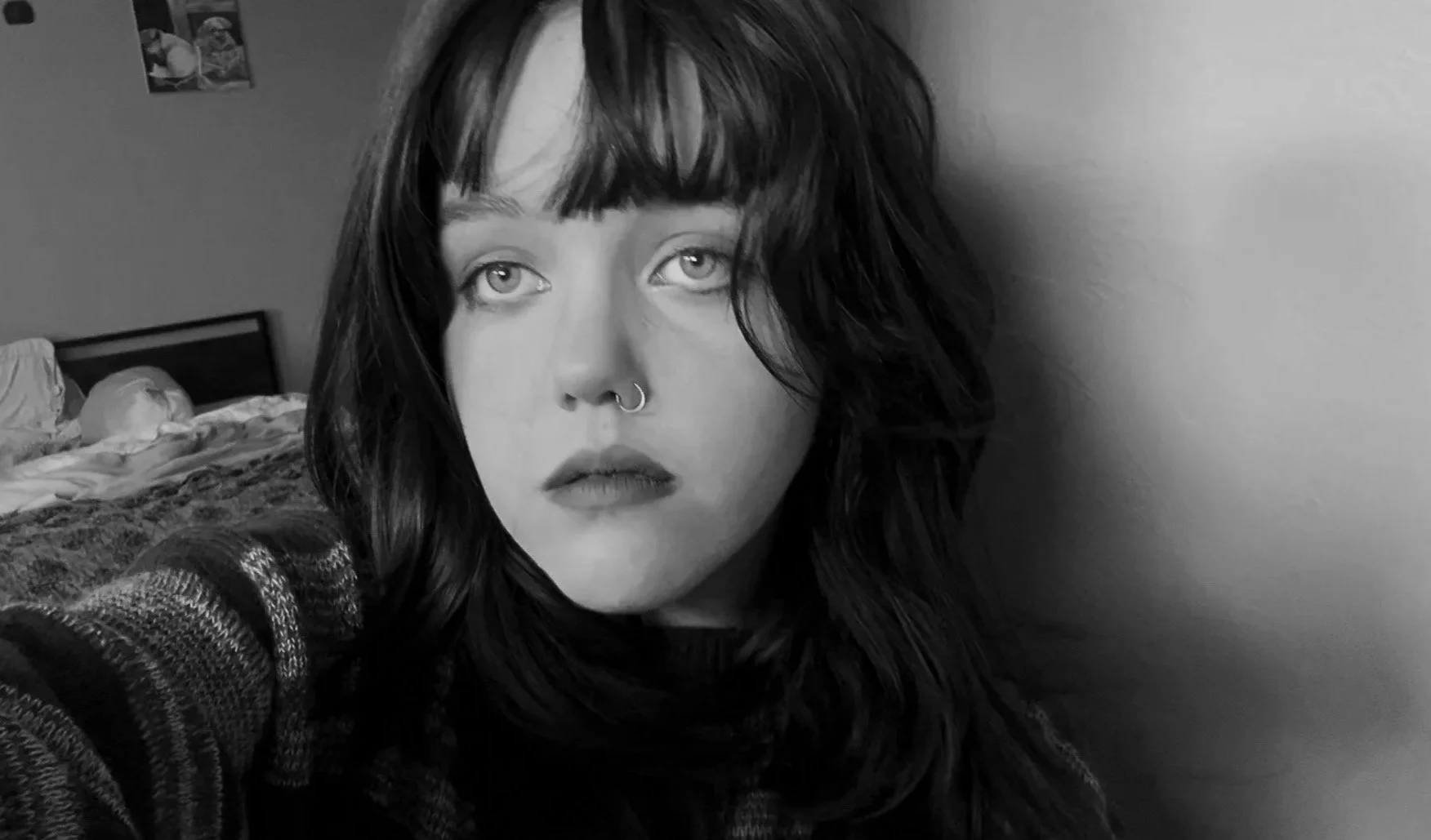 A black and white image of Love Martin, a brunette woman with a nostril piercing.