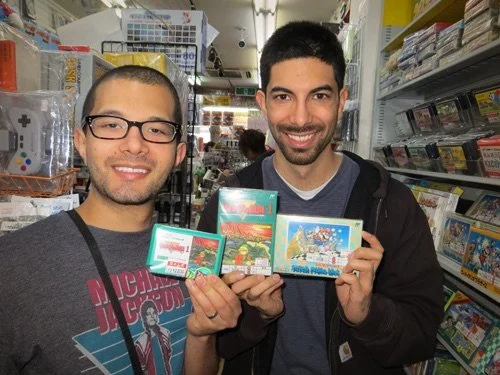 Jacob and Paul Stevens holding Riverman game artwork