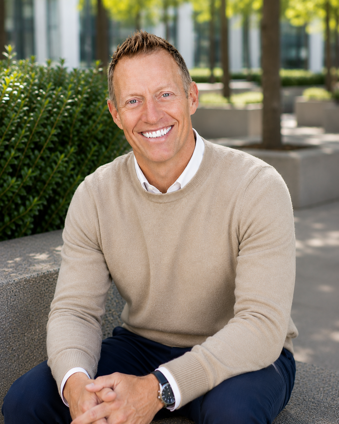 White male in beige sweater in park setting