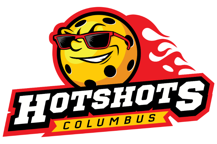 A cartoon emoji-like face of a yellow cookie with chocolate chips, wearing red sunglasses, smiling, with a red flaming background, and the text 'Hotshots Columbus' written below.
