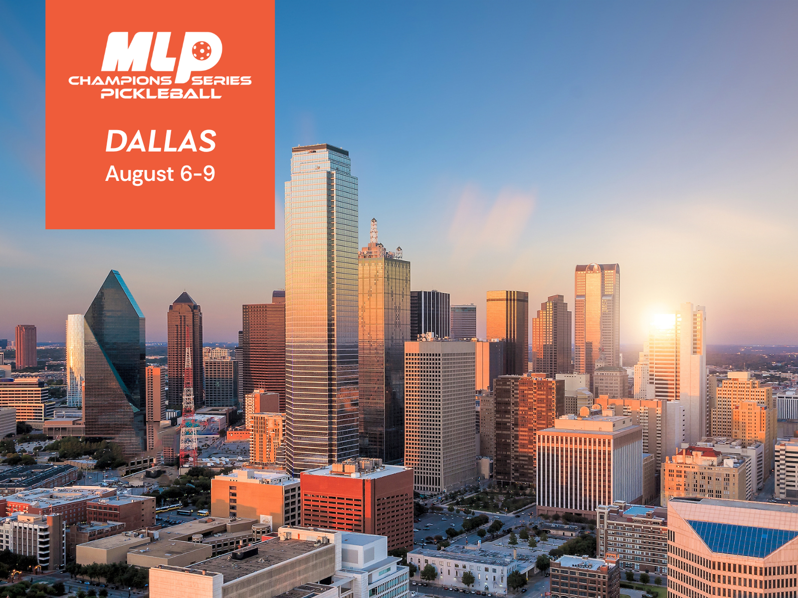Skyline of downtown Dallas at sunset with tall skyscrapers and a clear sky