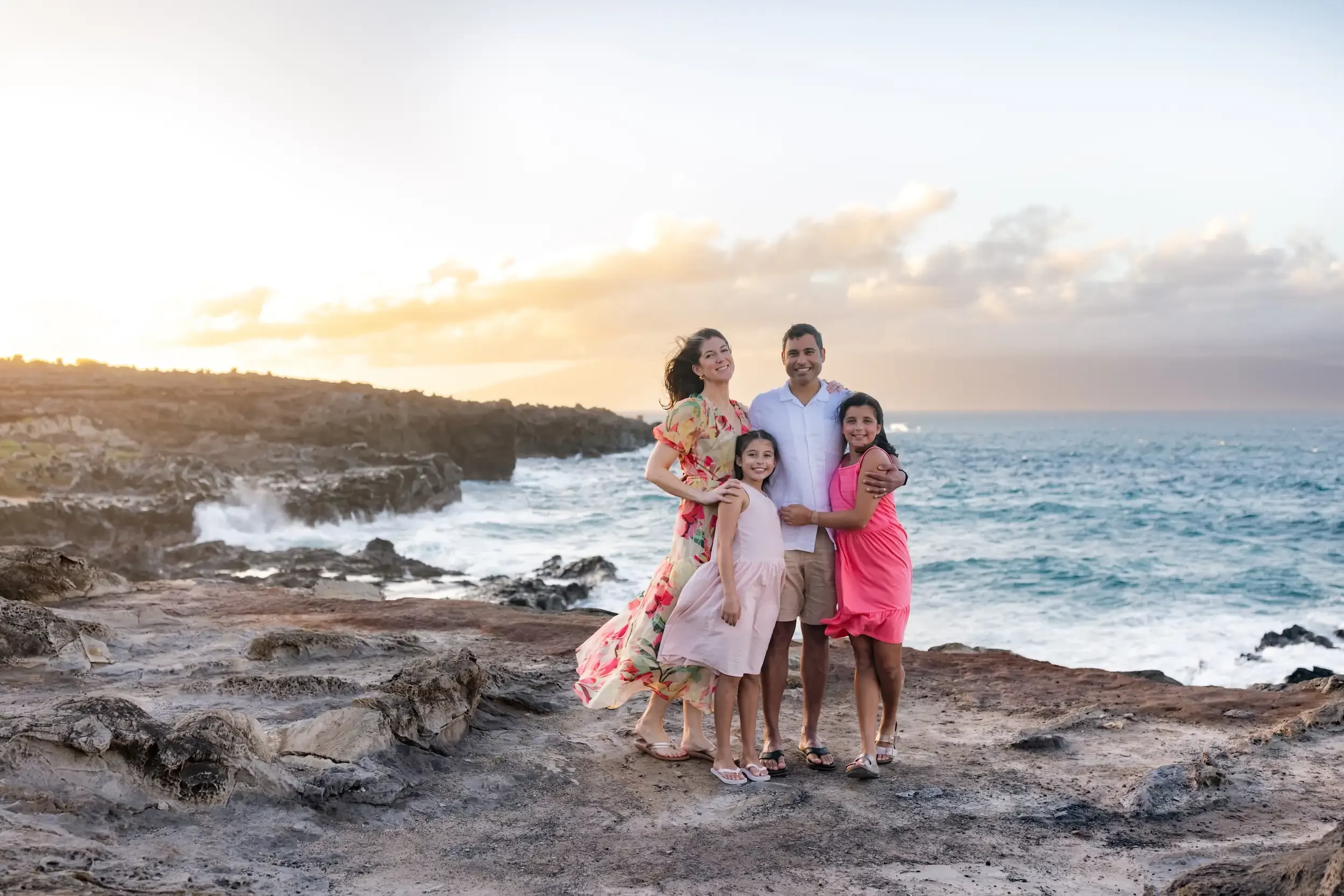 Dr. Jill Casey with her husband and two daughters at sunset on the Maui coastline — concierge family physician
