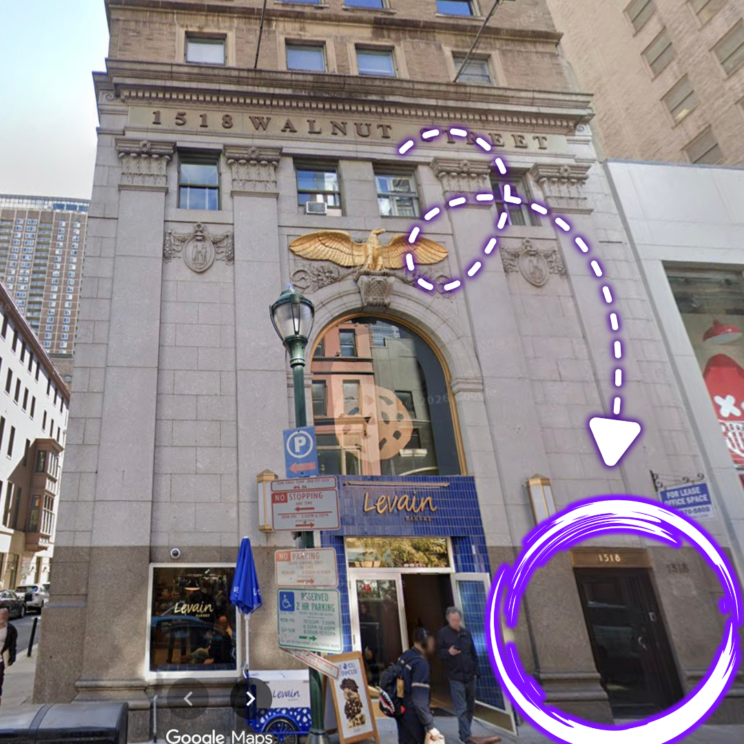 Building with the address 1518 Walnut Street, featuring gold eagle decoration above the arch, with purple dashed arrow pointing to an entrance on the right side, and a purple circle highlighting a door.