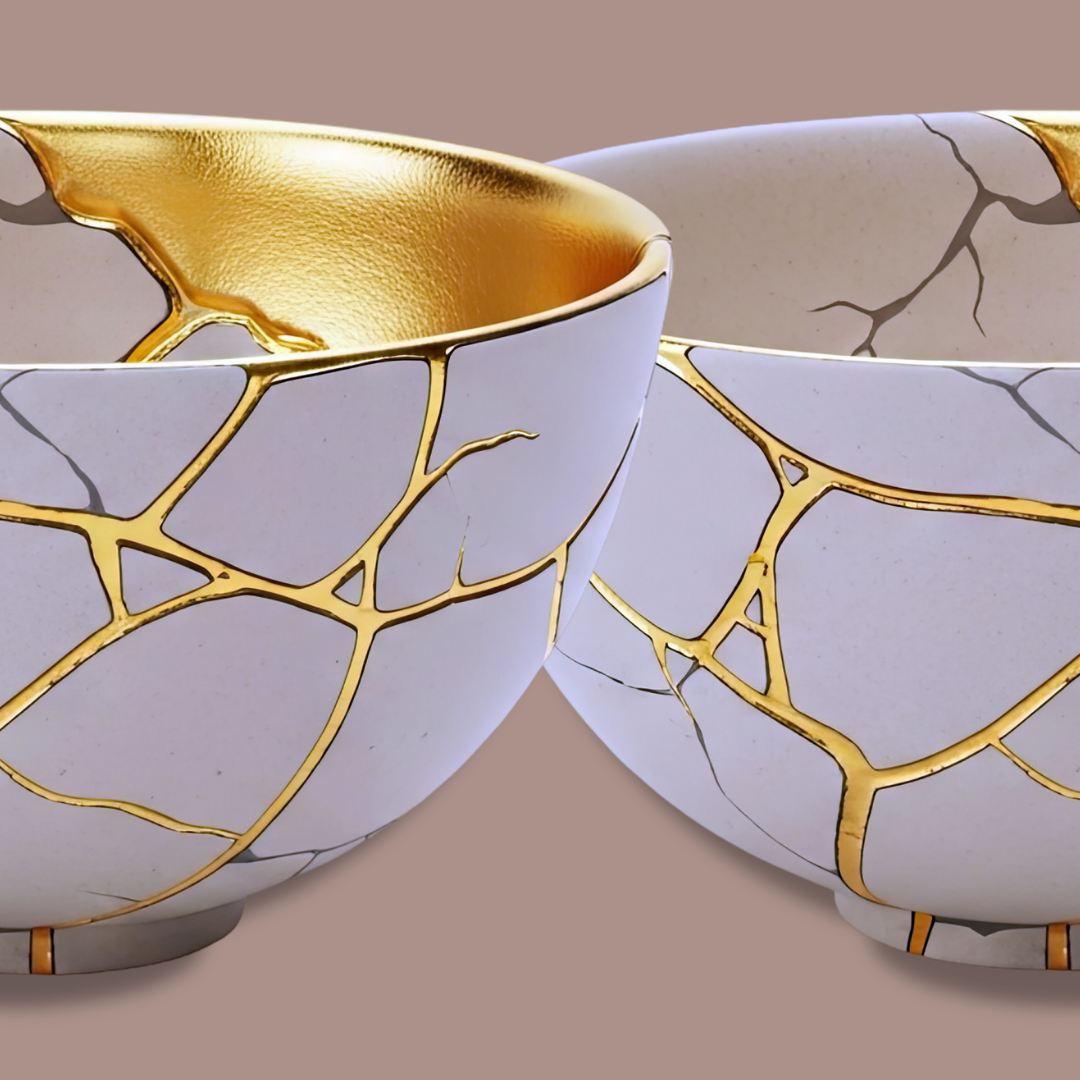Two broken ceramic bowls with gold accents, fused together with alternating gold and white designs, on a beige background.