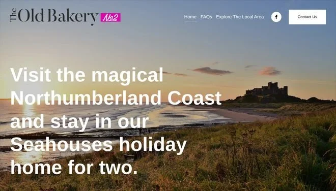 Website homepage for The Old Bakery, promoting visits to Northumberland Coast and Seahouses, featuring a scenic coastal landscape at sunset with a castle on a hill.