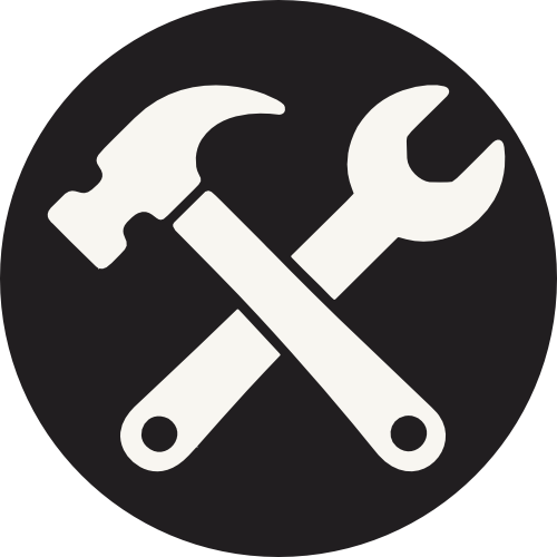Icon of a hammer and wrench crossed, on a black circular background.